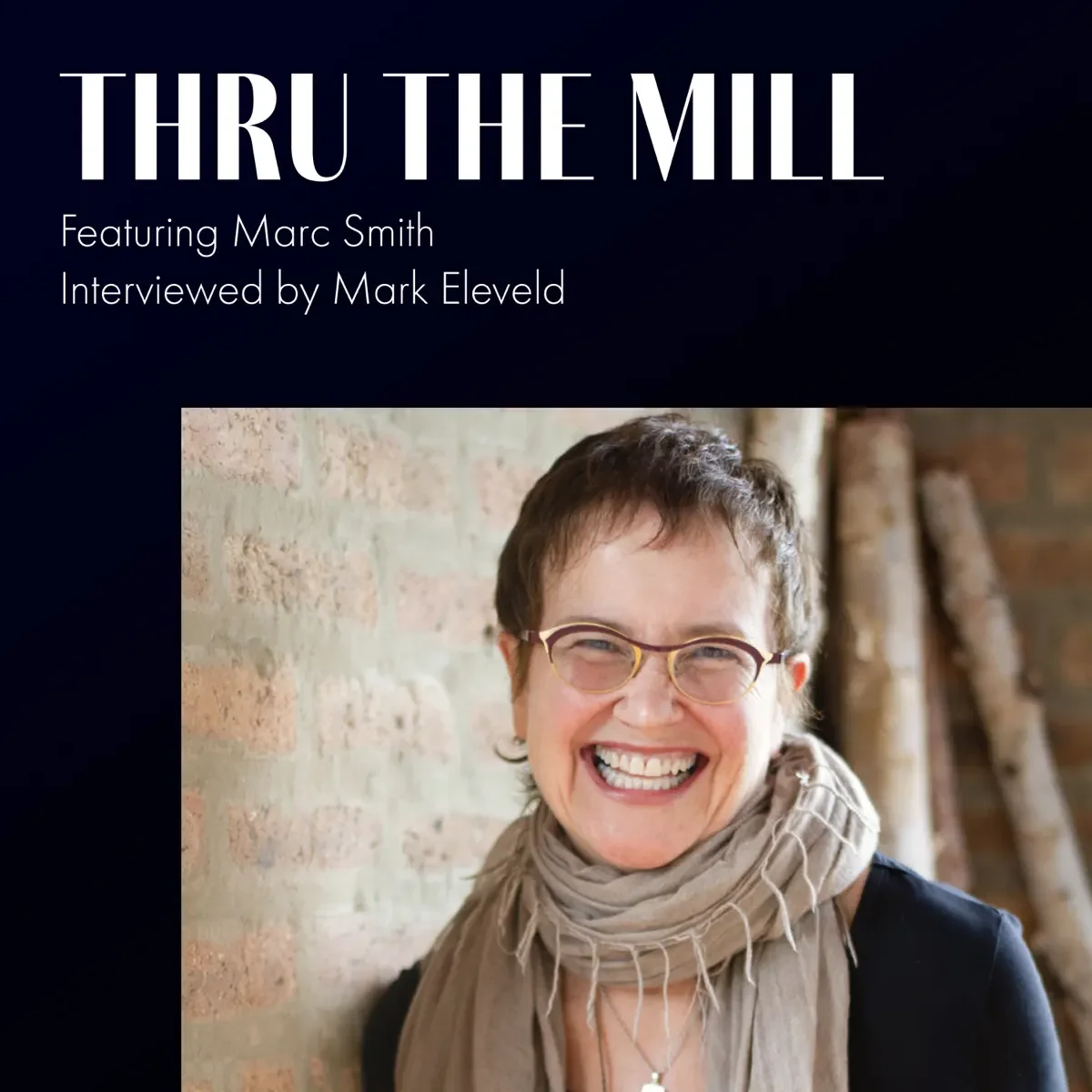 Cover image for the podcast 'Thru the Mill,' featuring a woman with short curly hair, glasses, and a light scarf, smiling in front of a brick wall.