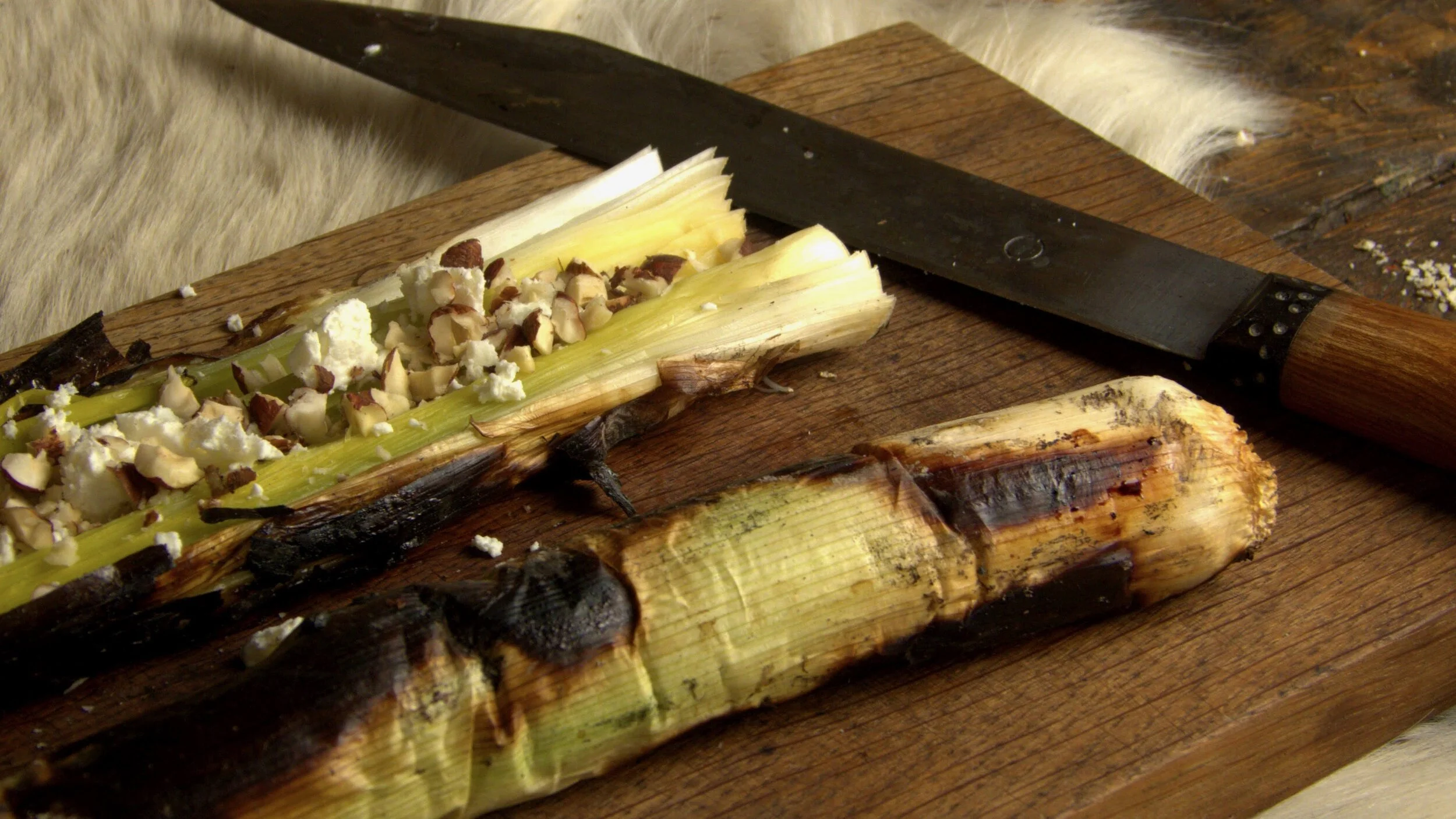 Ember charred leeks with cheese &amp; hazelnuts