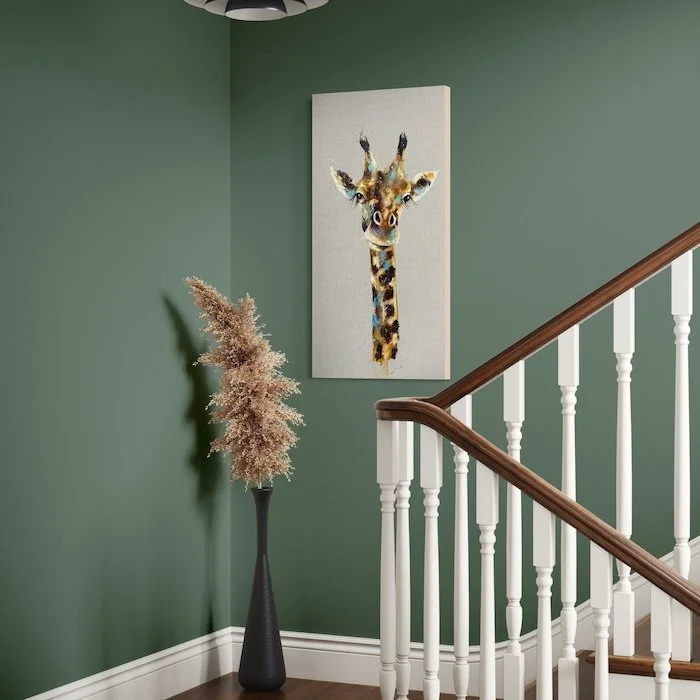 Galilea the giraffe in stairway farrow and ball green smoke wall.jpeg