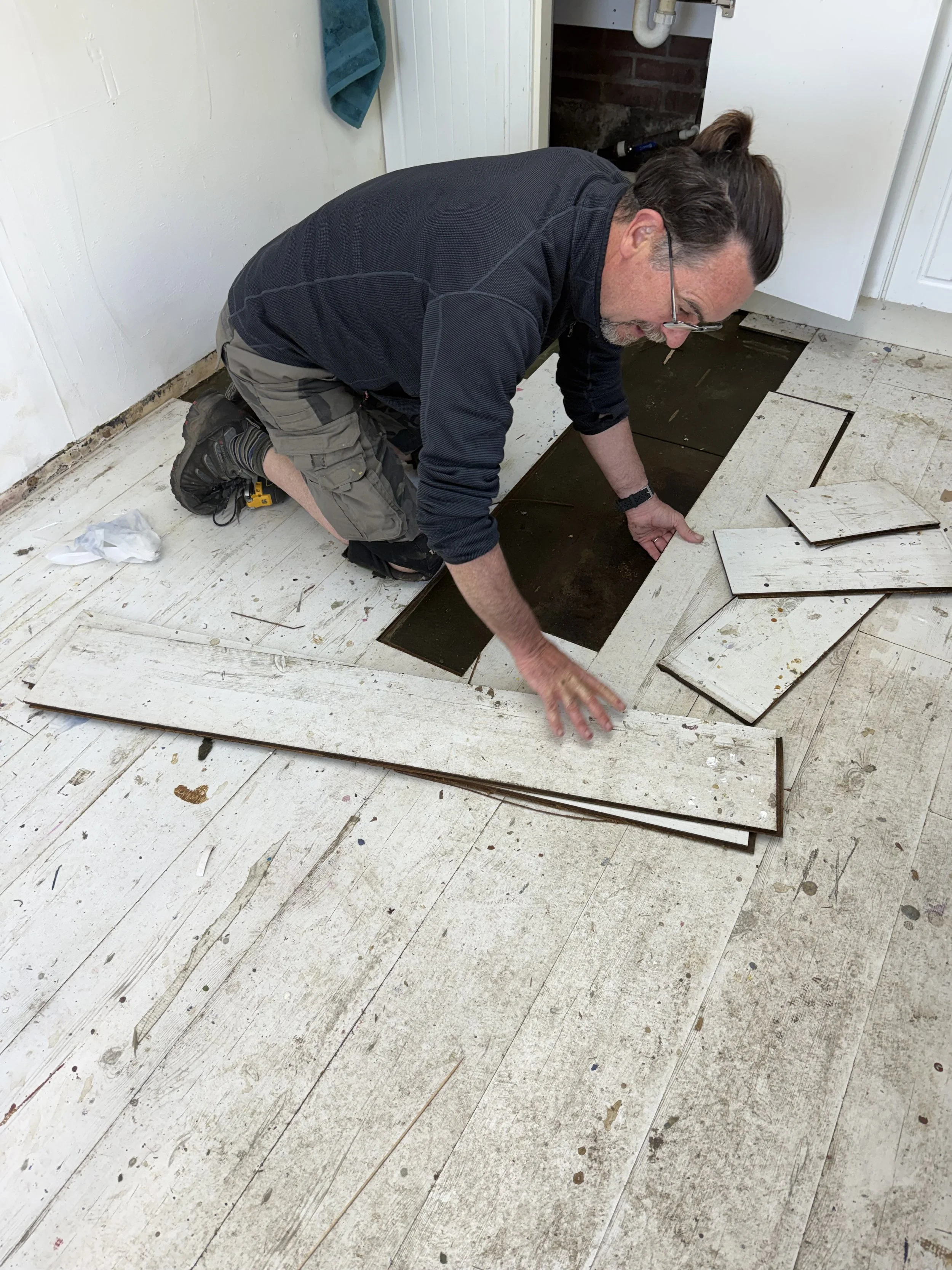 Phil lifting the floor of the studio to reveal wet underlay