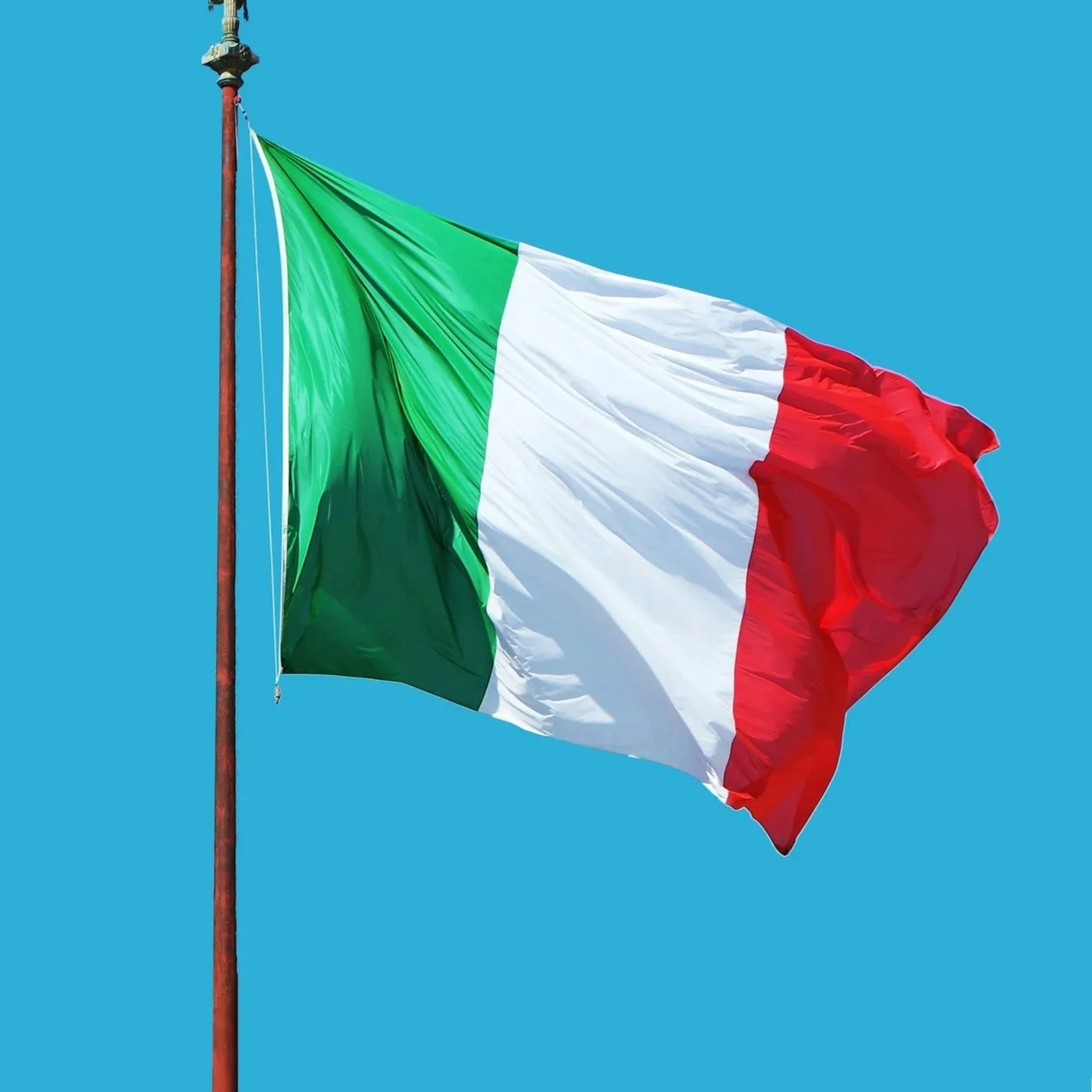 Italian flag flying against a clear blue sky.