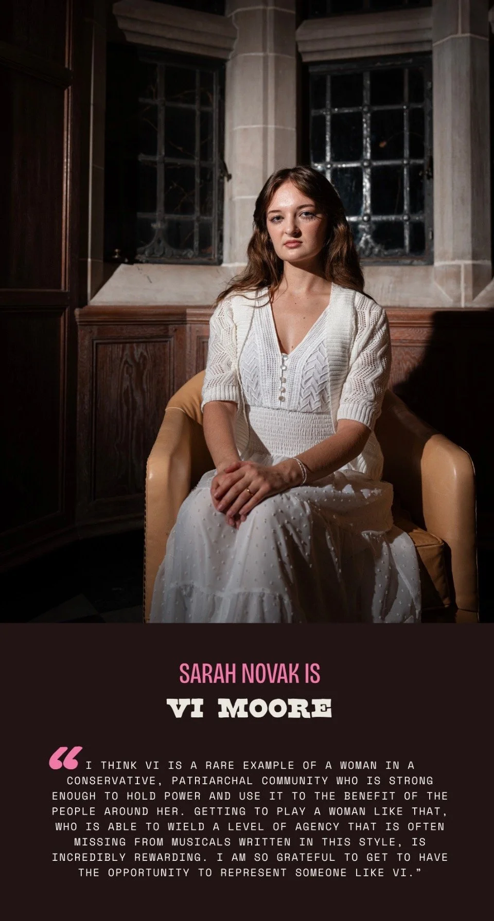 Portrait of a young woman with brown hair and light skin sitting on a beige armchair inside a church or cathedral, with large stained glass windows and stone walls in the background. She is wearing a white knit dress and looking at the camera with a neutral expression.