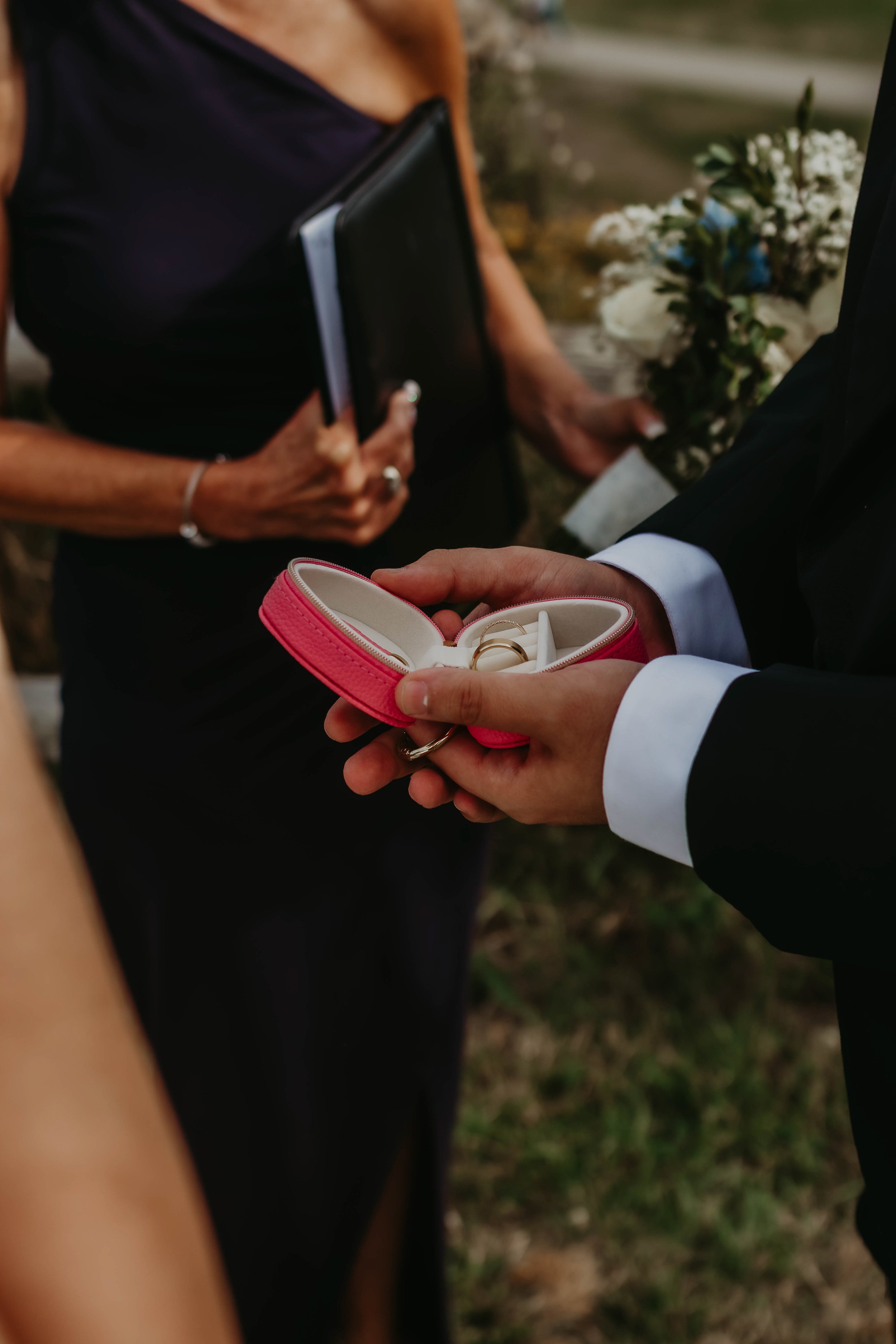 Hand holding a small decorative box with a handwritten note inside, addressed to Sarah for her birthday.