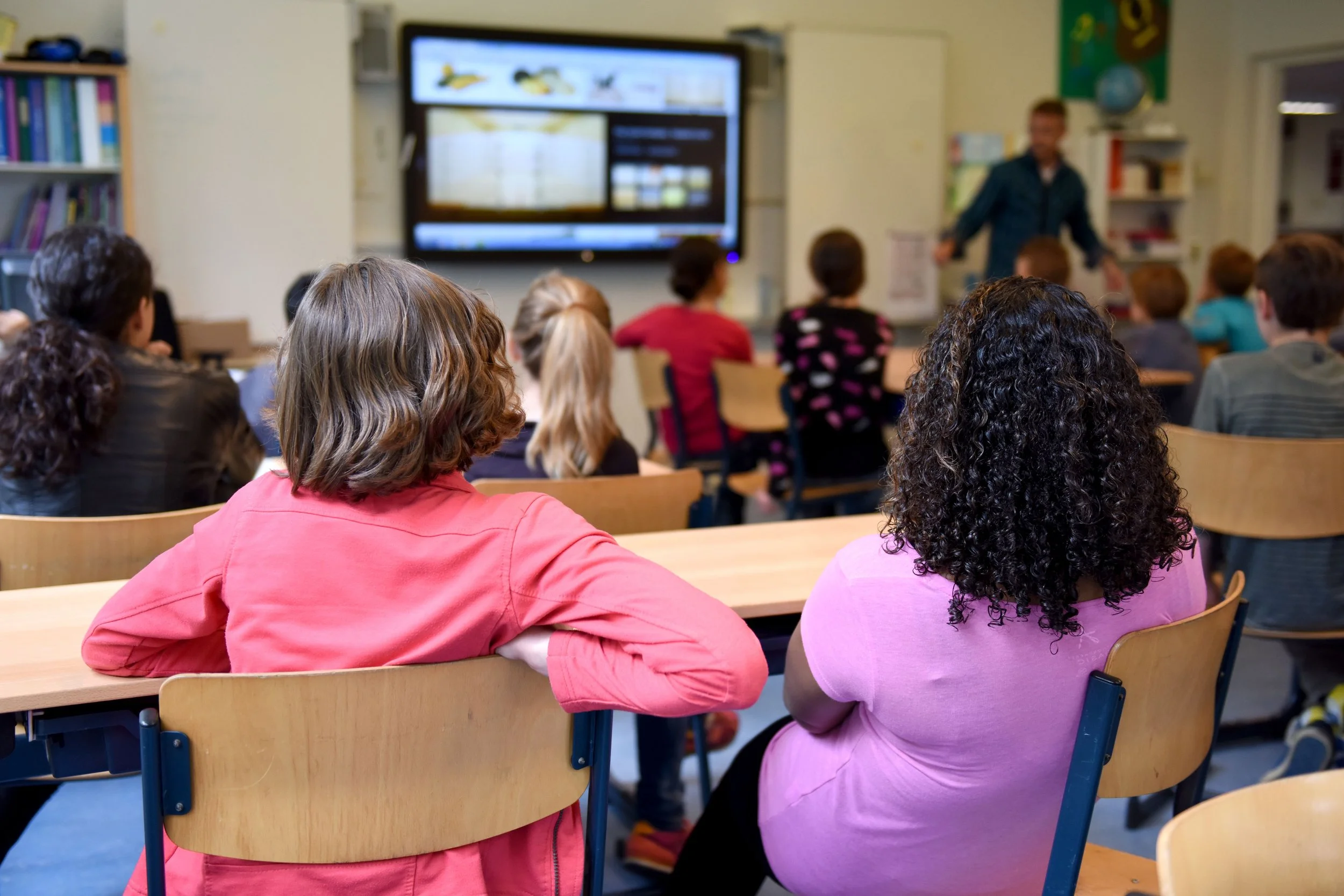 Students participating in an educational presentation in a classroom.