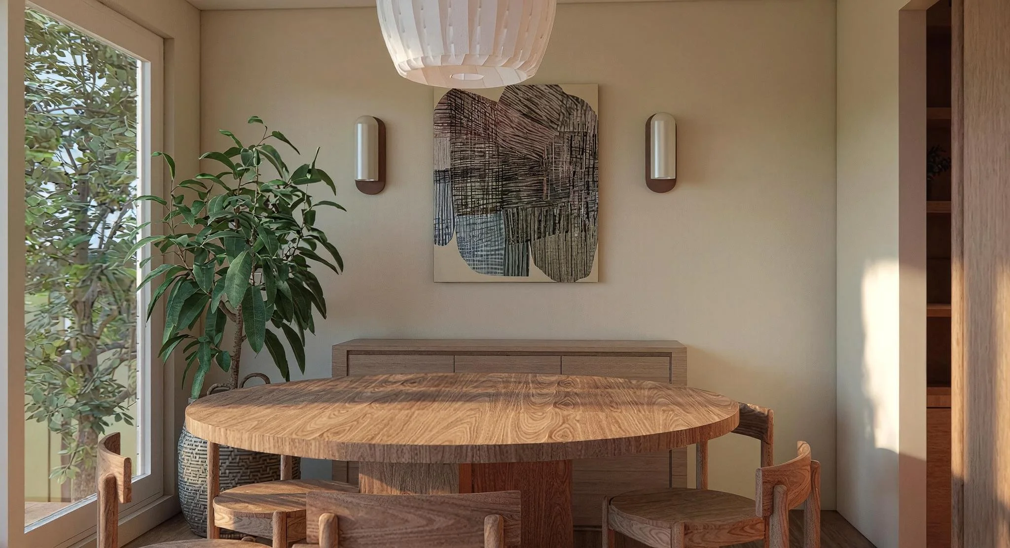 A dining area with a round wooden table, four wooden chairs, a large potted plant beside a glass door, wall-mounted lights, a framed abstract art piece on the wall, and a wooden cabinet beneath the artwork.
