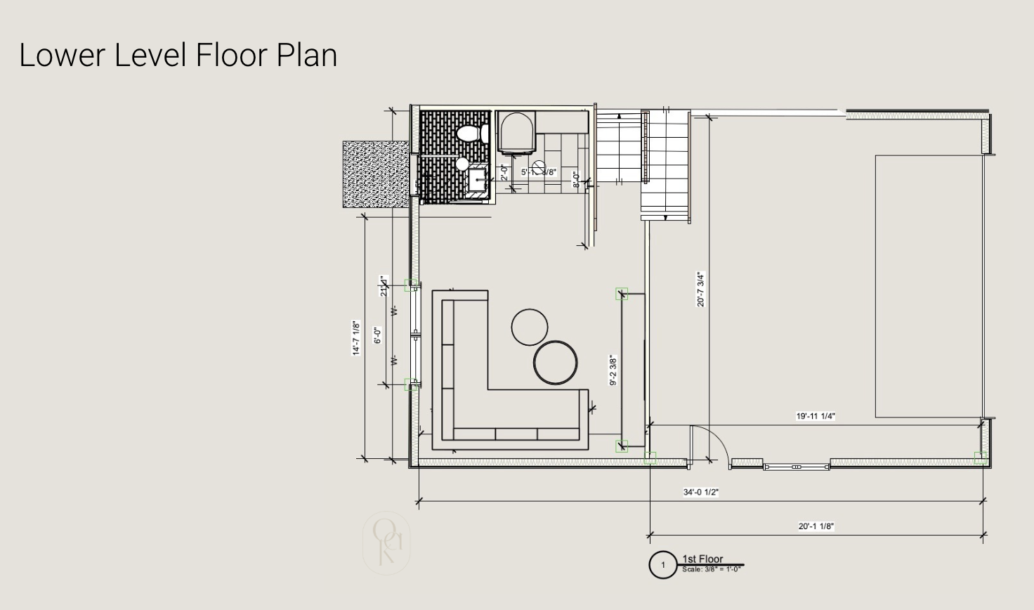 Architectural floor plan of a lower level, showing a living room with L-shaped sofa and two round coffee tables, a bathroom with toilet and shower, and a staircase leading upstairs.