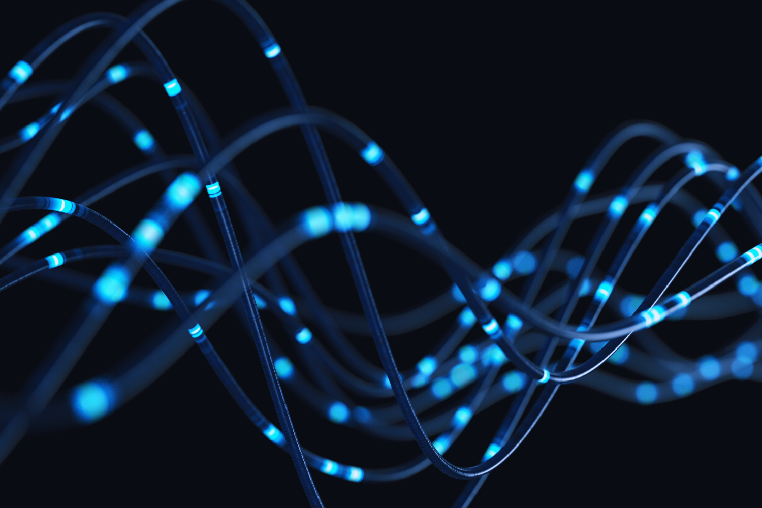 Close-up of glowing blue and black twisted fiber optic cables against a dark background.