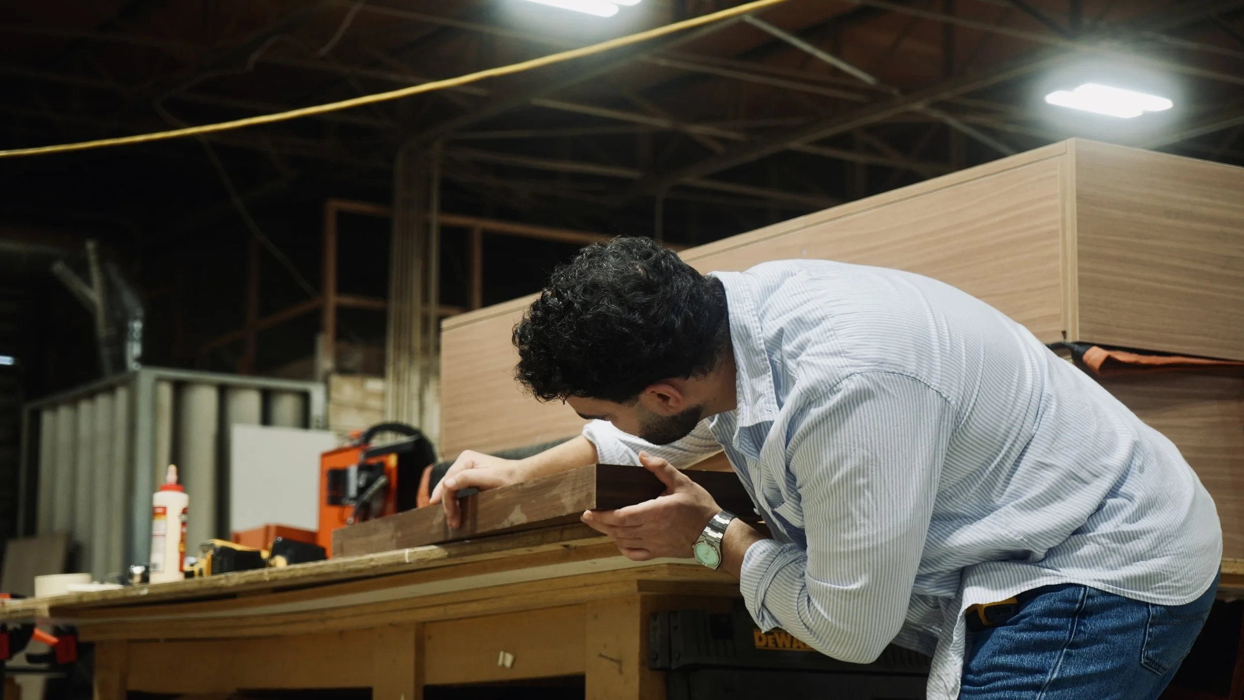 Anthony checking a cabinet detail in the workshop