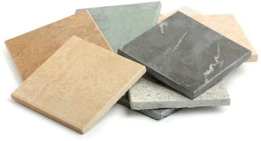 A collection of various square stone tiles in different colors and textures.