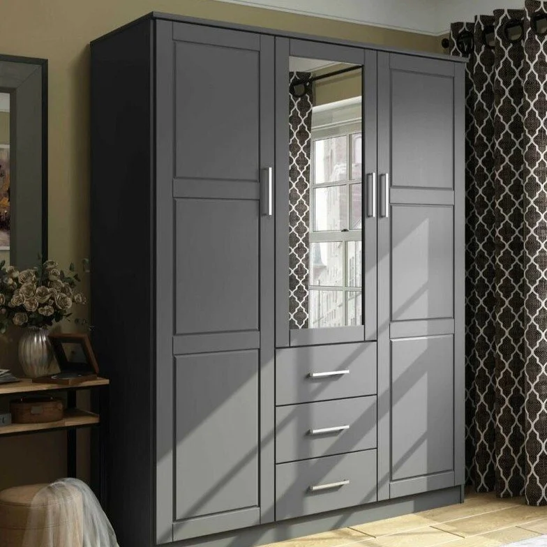 Gray wardrobe with a mirror door, three drawers, and adorned with modern handles, set against a wall with patterned curtains and a window.