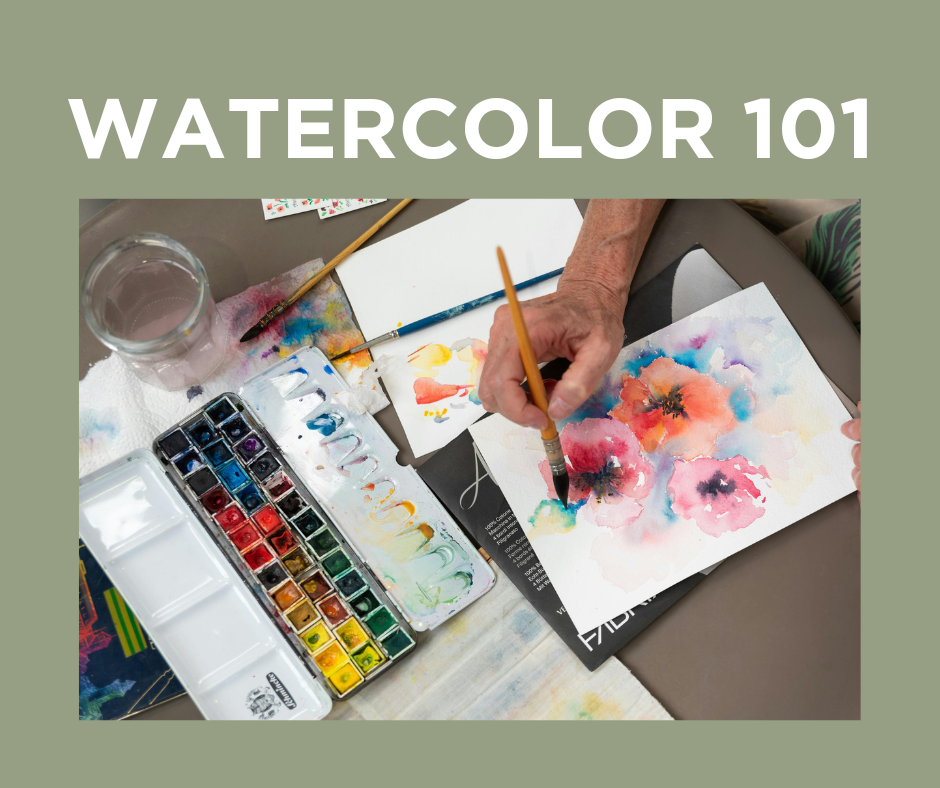 A person watercolor painting colorful flowers on paper, with watercolor paints, brushes, and a glass of water nearby.