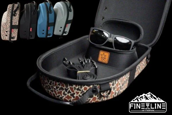 Open carrying case with sunglasses, a small charger, and a portable device inside. Four other cases in different colors are lined up in the background.