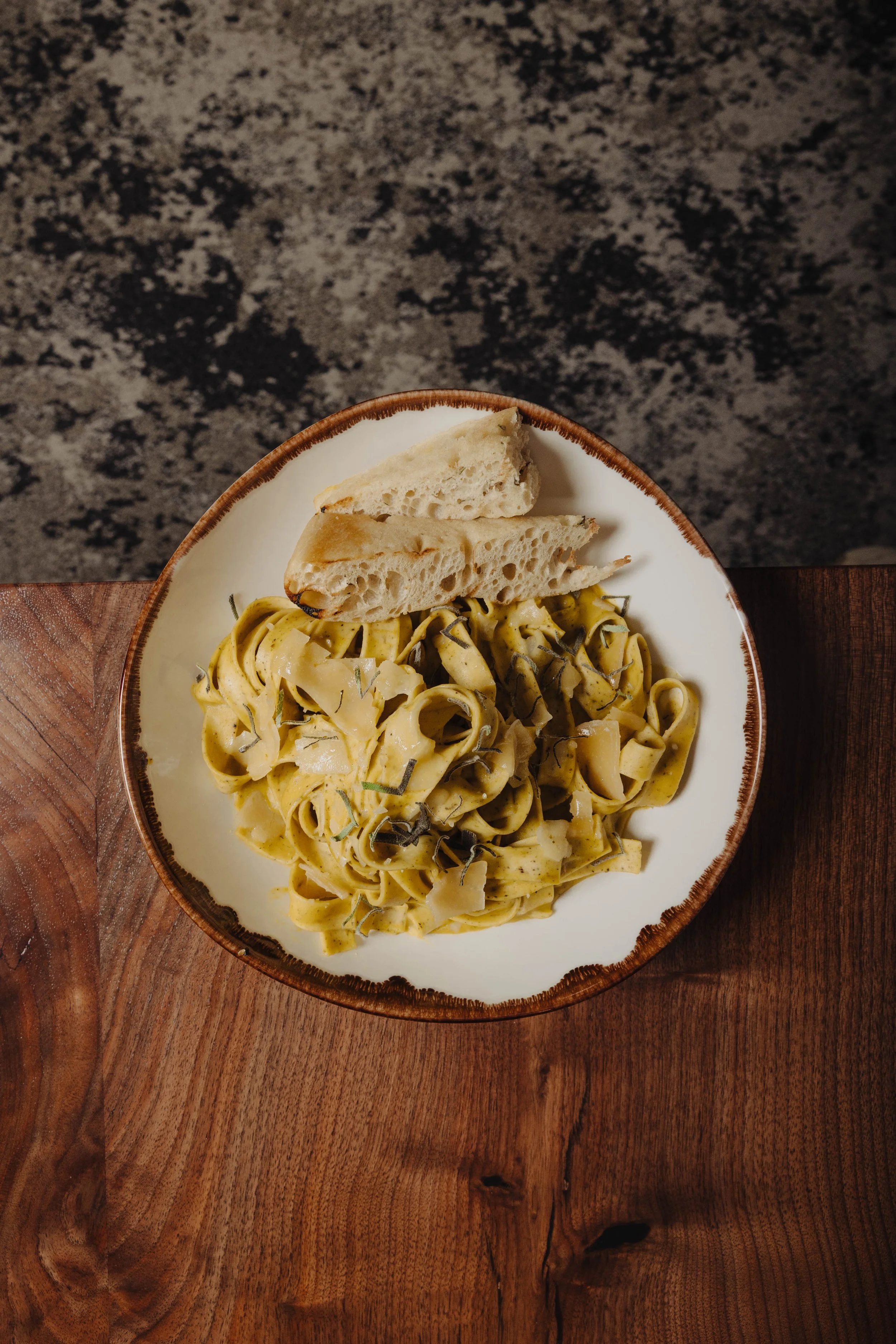 Acorn Squash Papperdelle Pasta featuring roasted acorn squash, sage, pappardelle pasta, grilled focaccia, Pecorino-Romano 