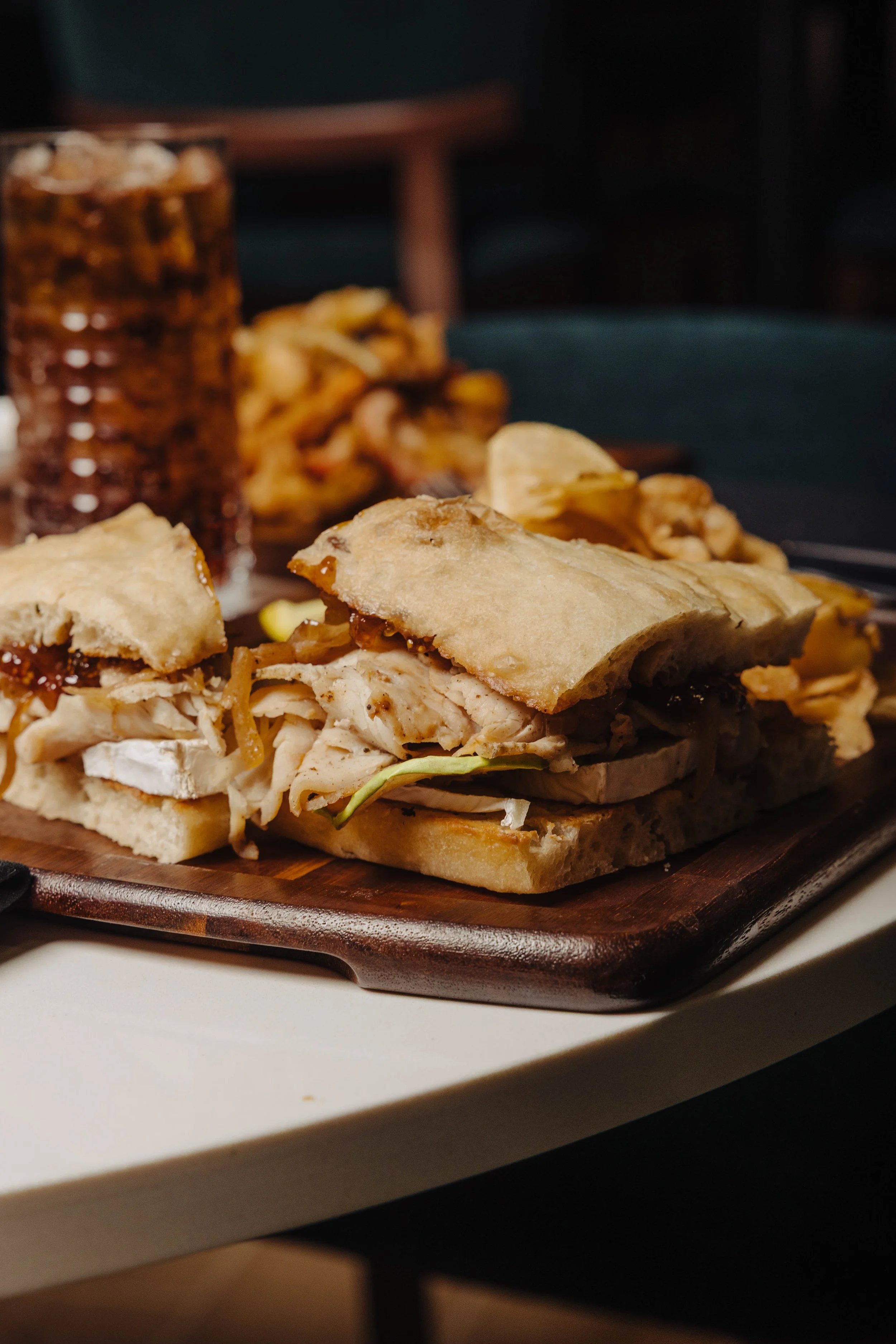 Harvest Turkey & Brie Handheld featuring toasted focaccia, roasted turkey, brie, caramelized onion, granny smith apples, fig jam