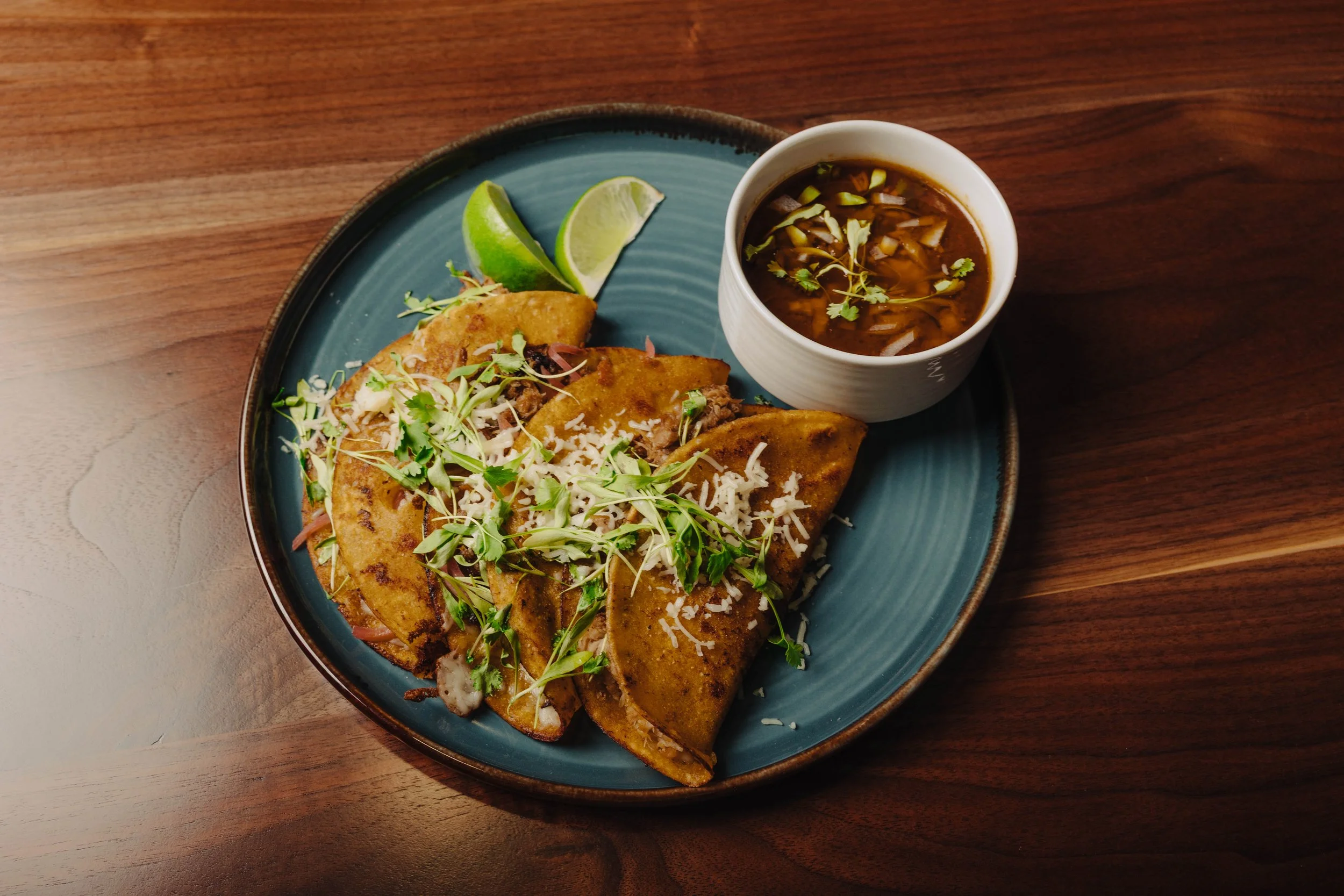 Westside Barbacoa Tacos featuring corn tortilla, plant based barbacoa, pickled red onion, lime, cilantro, salsa verde
