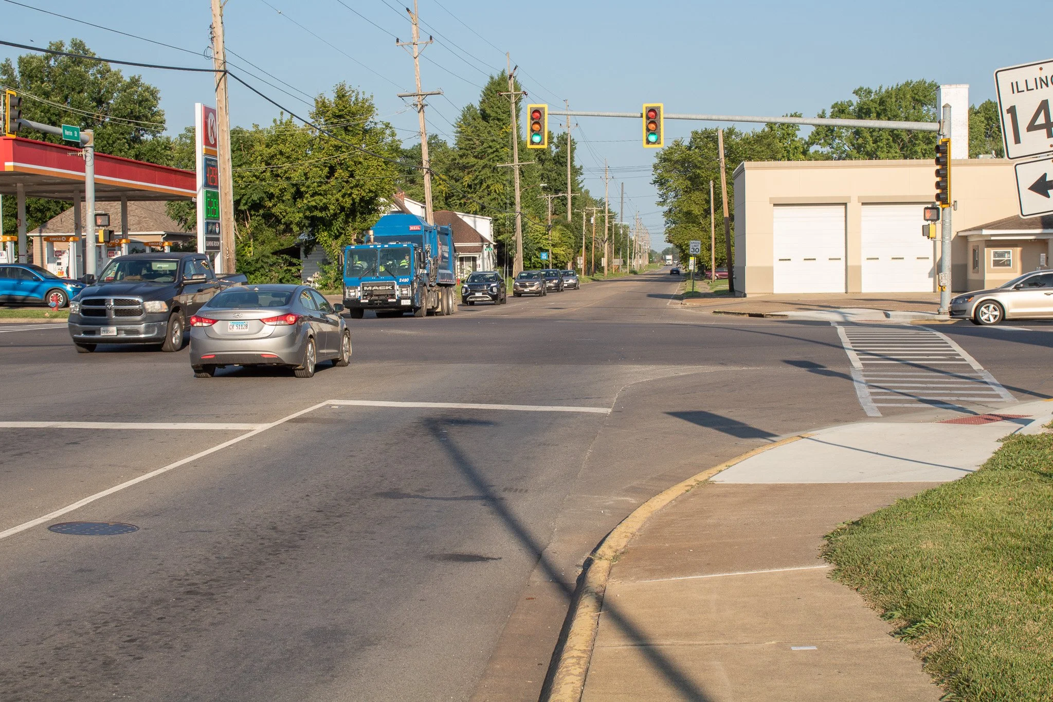 A busy roadway intersection next to a gas station
