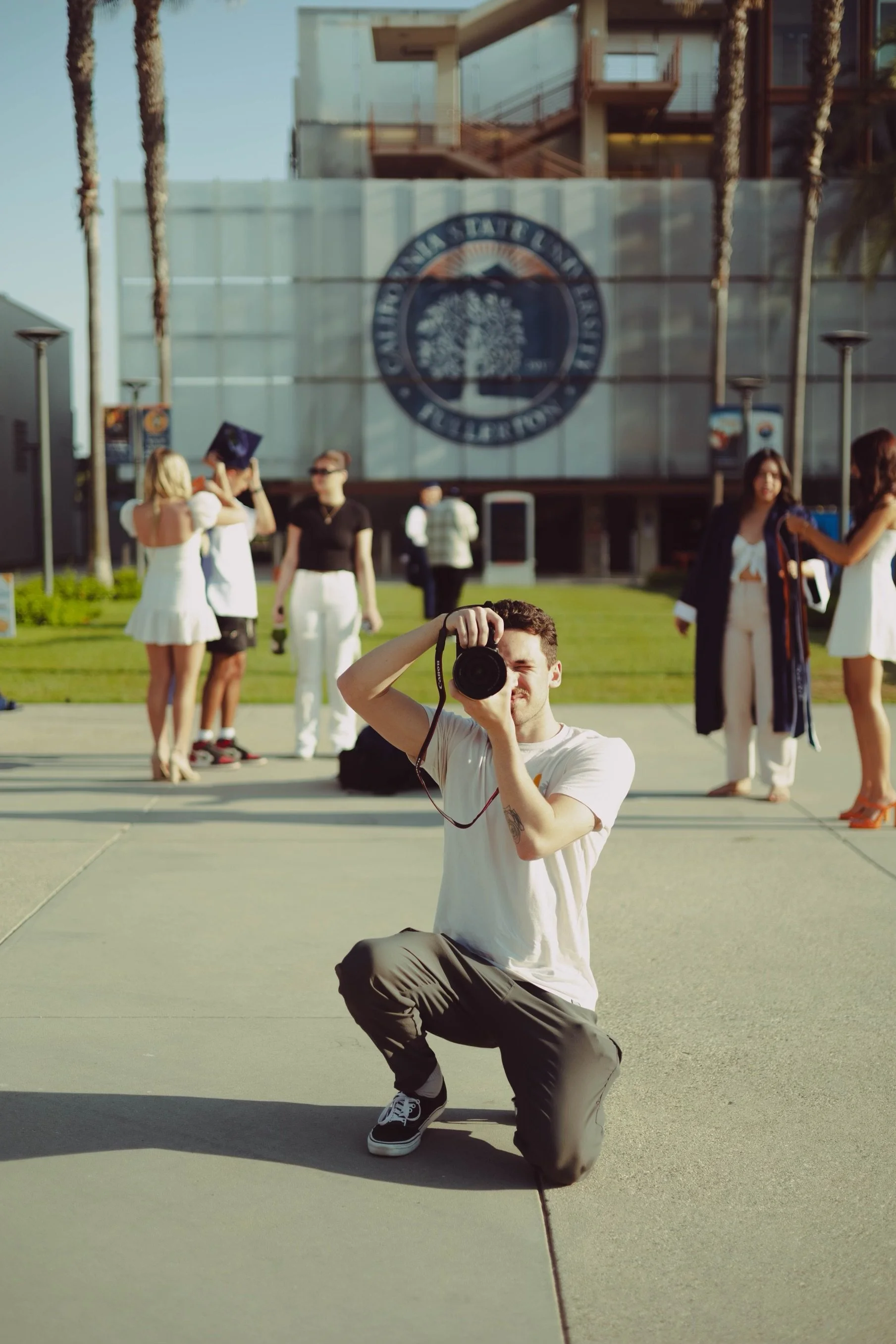 Camden Gunter, founder of Eleventh Horizon Media taking a photo at a senior portrait session.