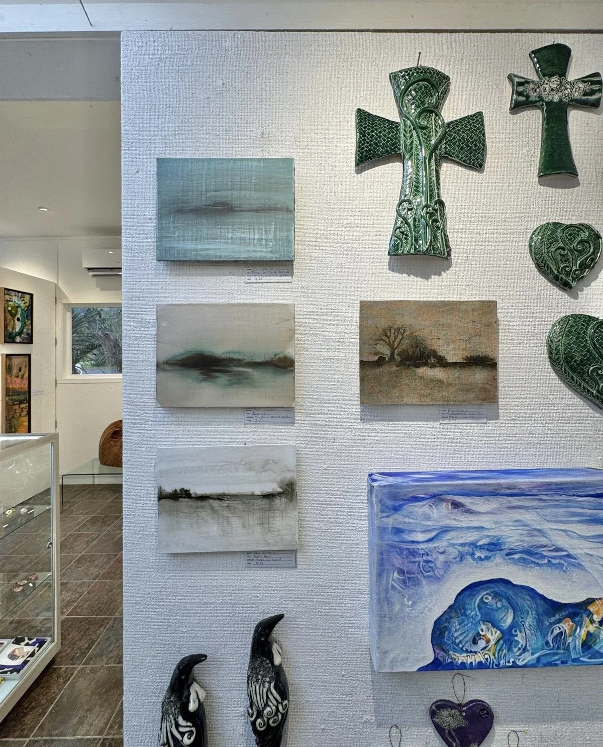 Four small paintings at West Coast Gallery, Piha, NZ, 2026.