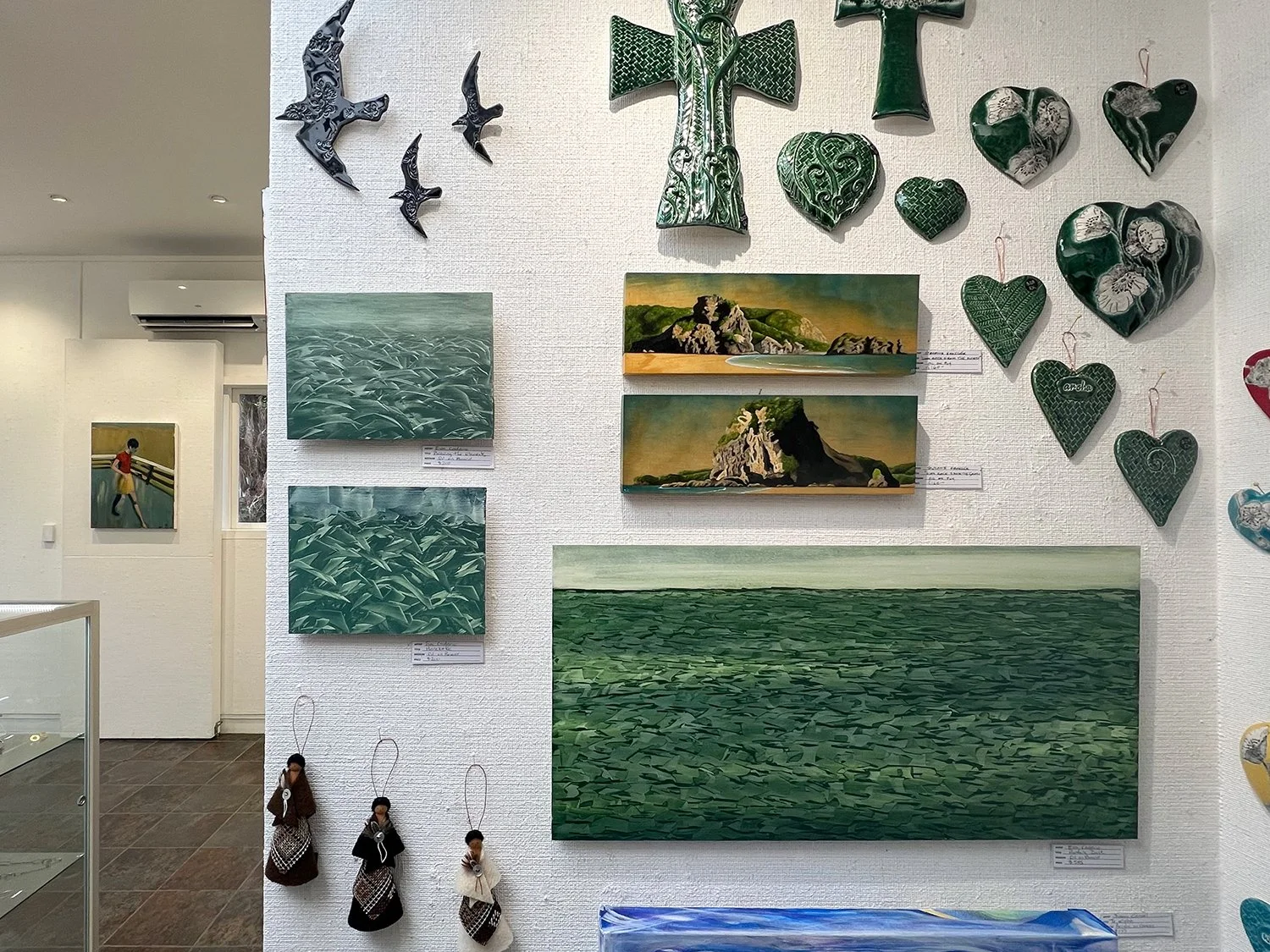 Two small and one medium sized painting at West Coast Gallery, Piha, NZ, 2026.