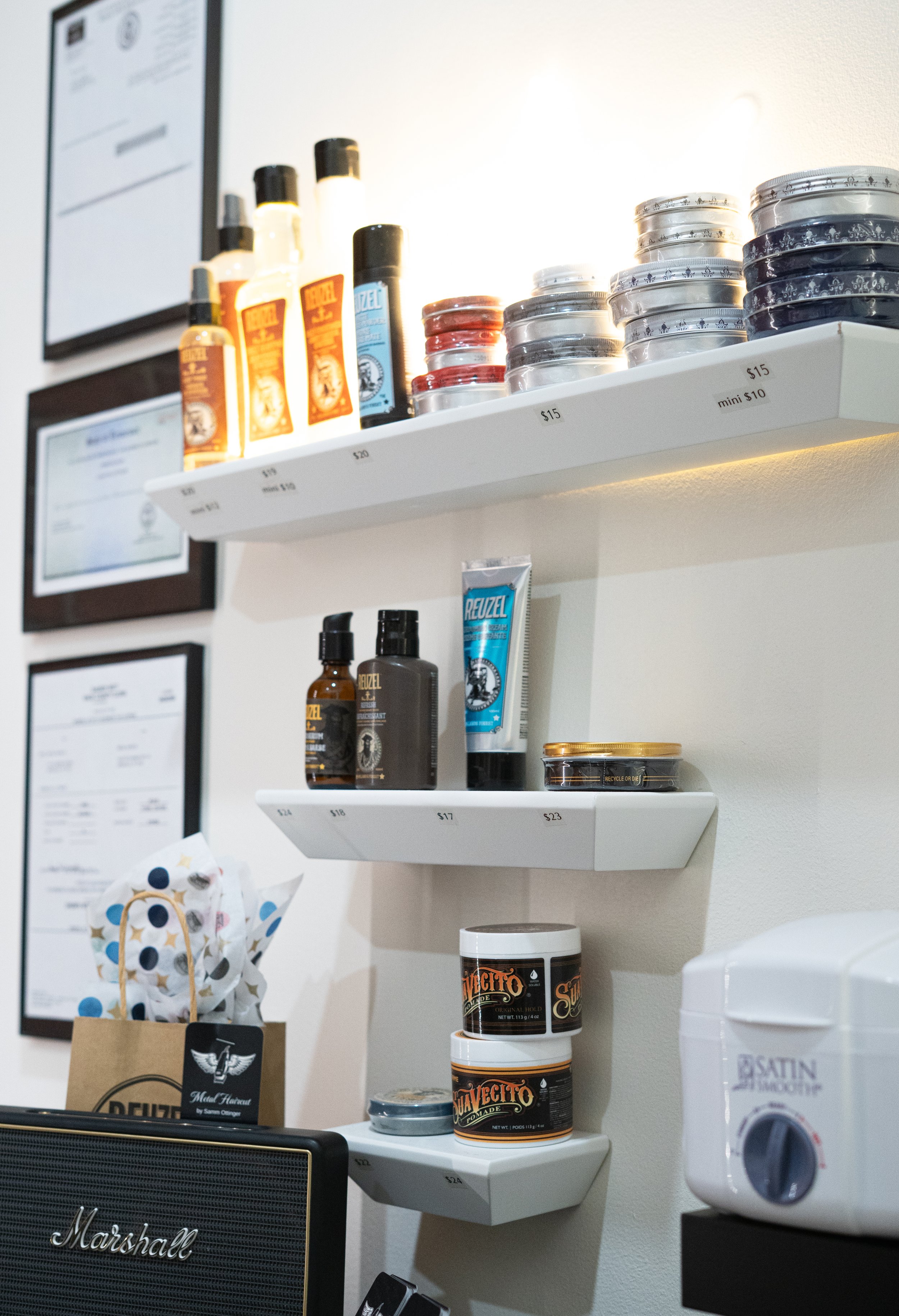 Shelves with various toiletries and grooming products, including creams, sprays, and jars, arranged in a store or salon setting.