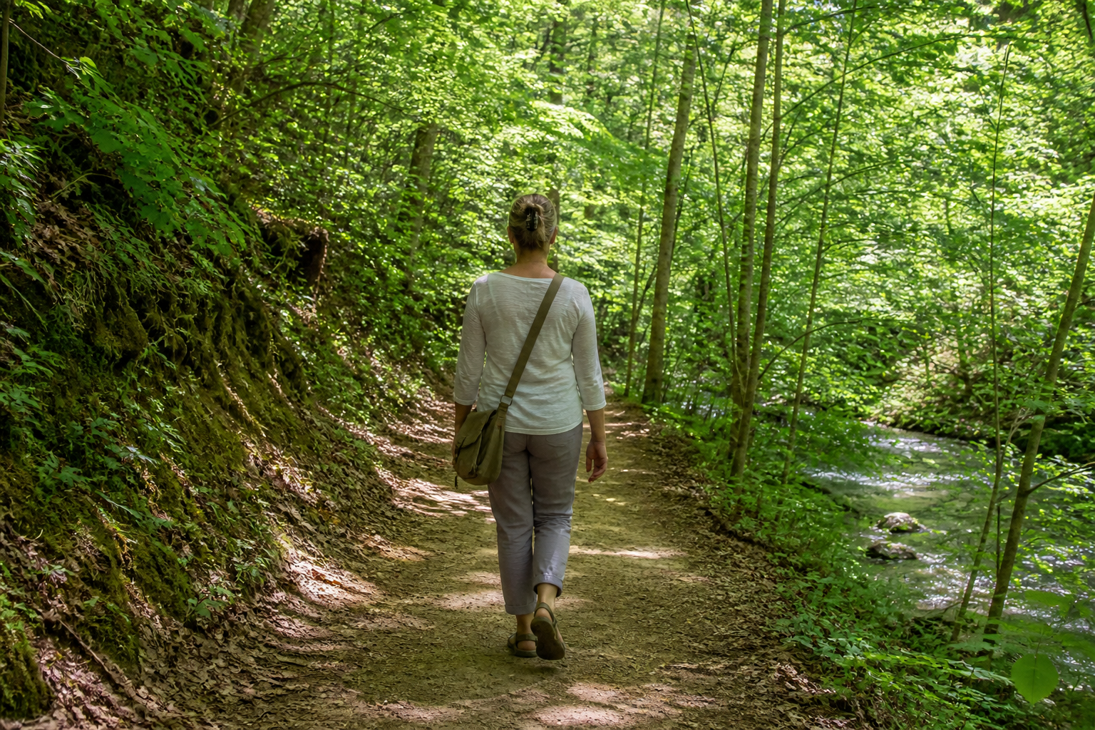 Adult taking a peaceful walk on a nature trail. Gentle movement for emotional integration after an EMDR intensive in NC.