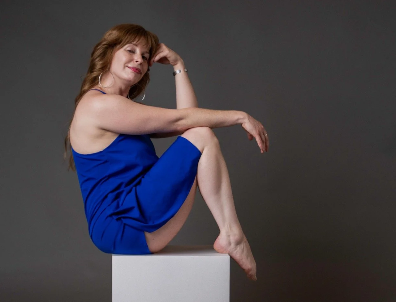Female model in a blue dress sitting for a portfolio session at Model Muse Studio Fayetteville NC-Model Muse Studio