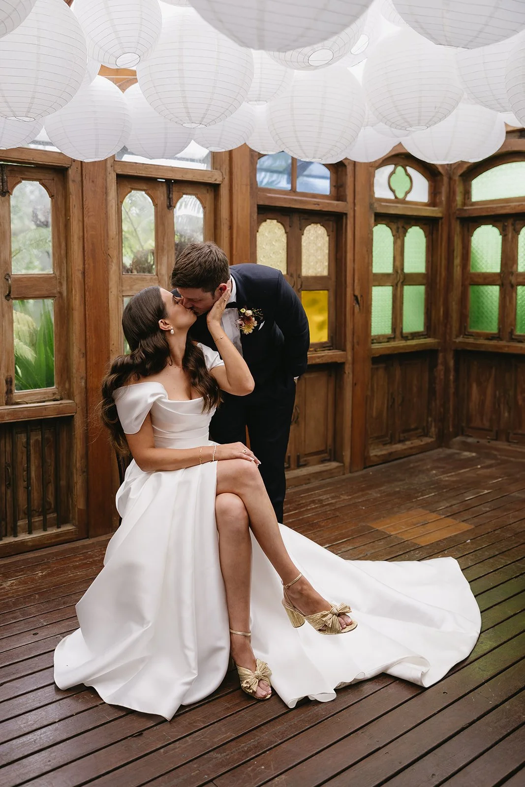 A Couple Kissing Indoors During Their  Wedding Reception At Leaves And Fishes