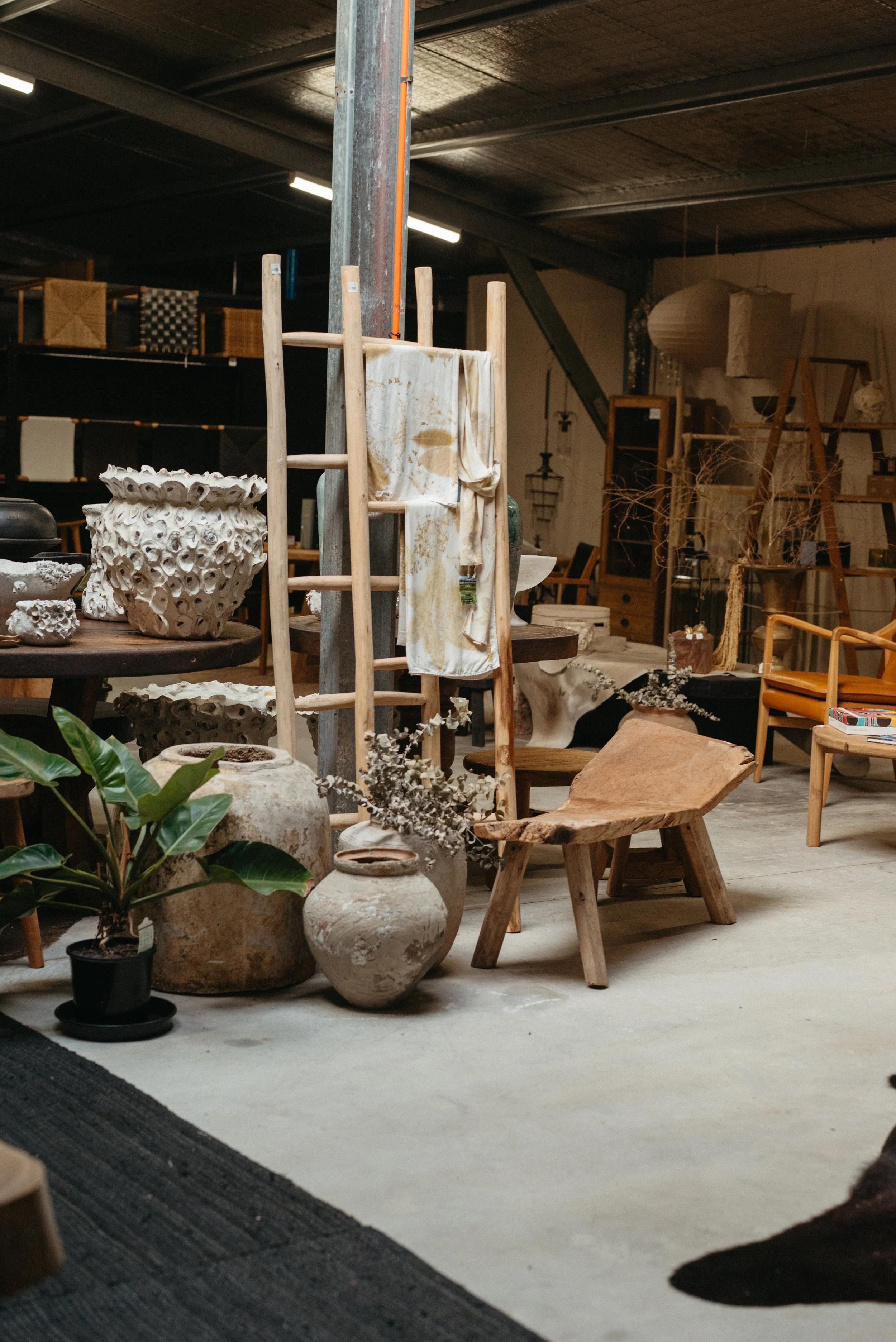 Rustic Interior with handmade ceramic vessels, wooden furniture, and natural textures at the Trove