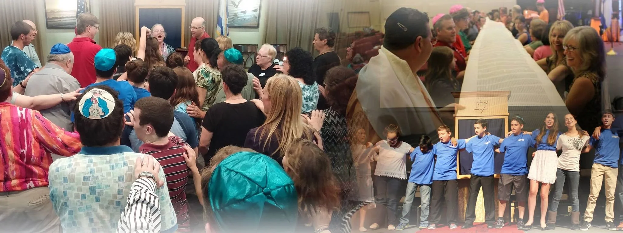 A large gathering of people at an indoor event with some individuals wearing kippahs, and a group of children standing together on a stage or platform, some with their arms around each other, during a cultural or community celebration.
