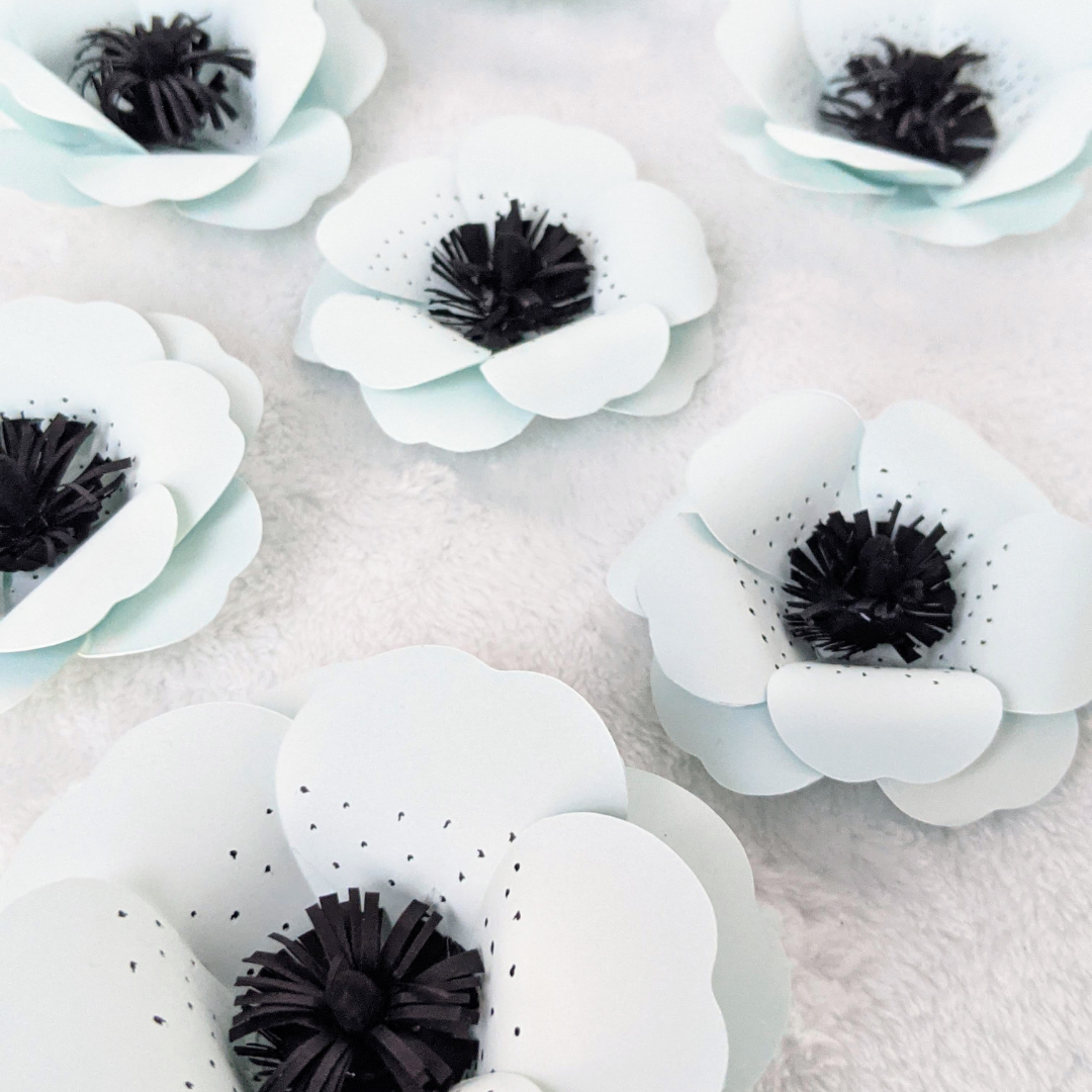 Handmade turquoise paper flowers with eyelash centers – Designs by Lorraine T
