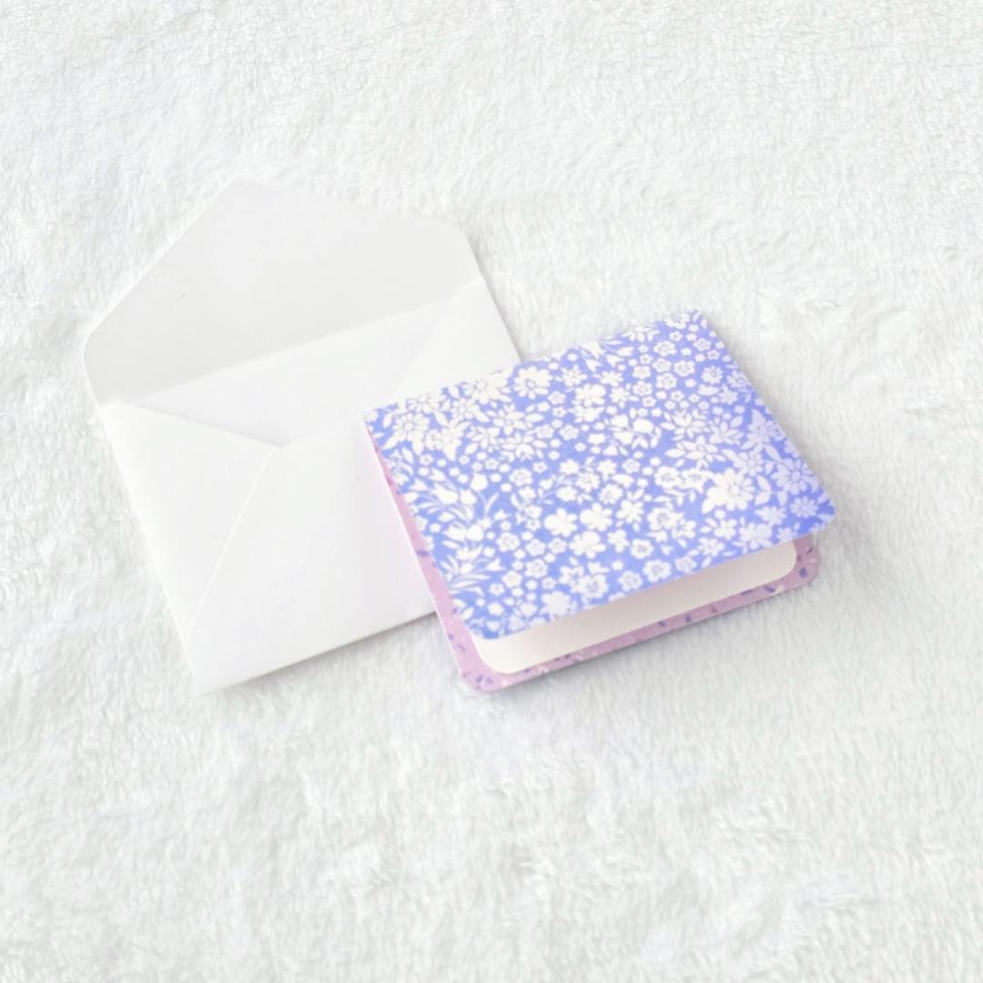 Blue Background with White Flowers and white envelope.png