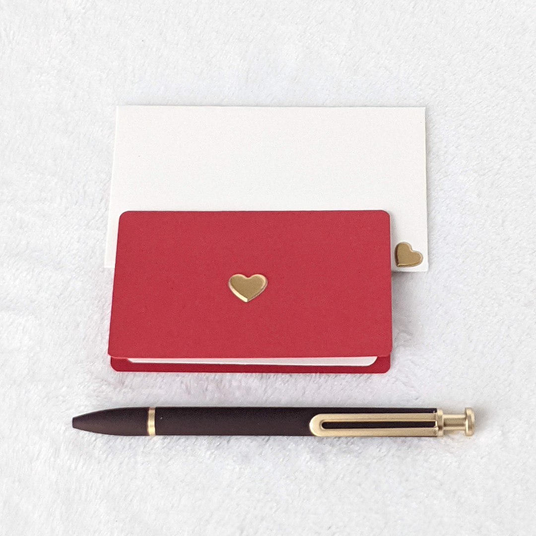 Mini off-white envelopes and red note cards with gold hearts