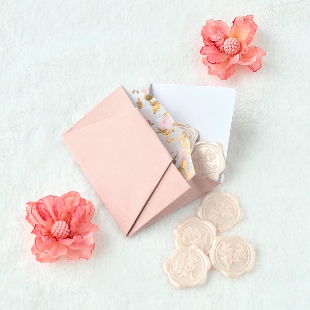 Blush Mini envelope with powder pink wax seals and flowers.png