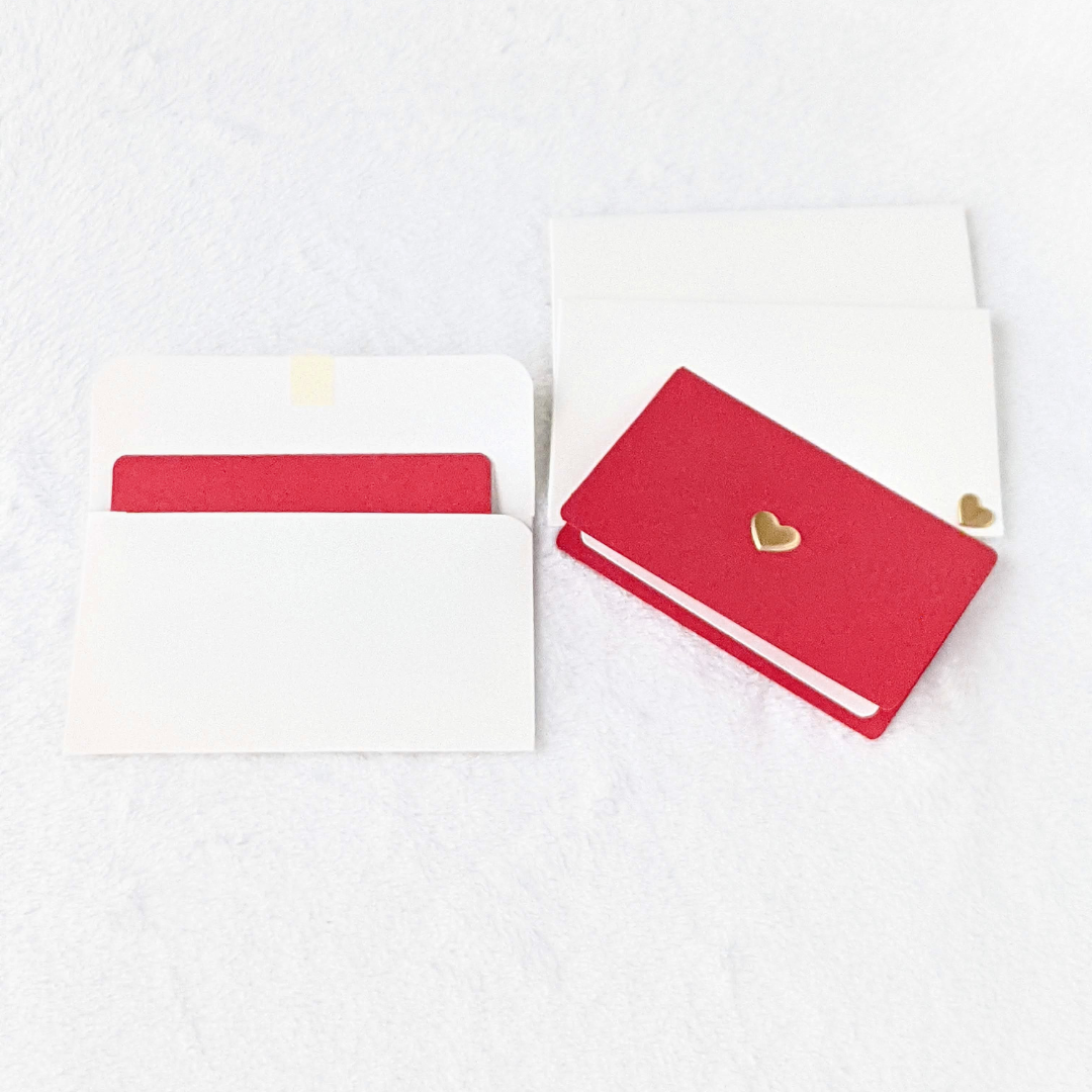 Mini off-white envelopes and red note cards with gold hearts