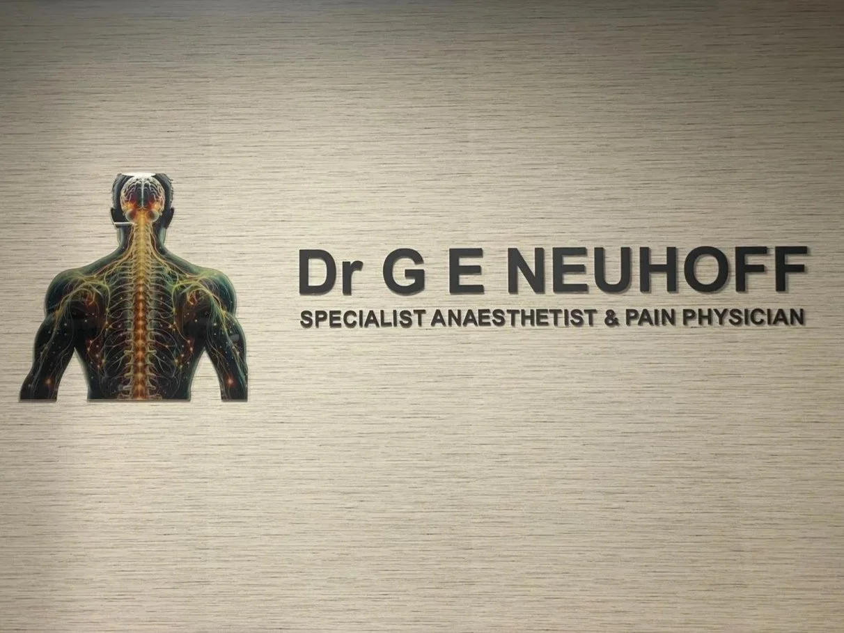 Business signage for Dr. G E Neuhoff, a specialist anesthetist and pain physician, featuring a graphic of a human back with nervous system illustration.