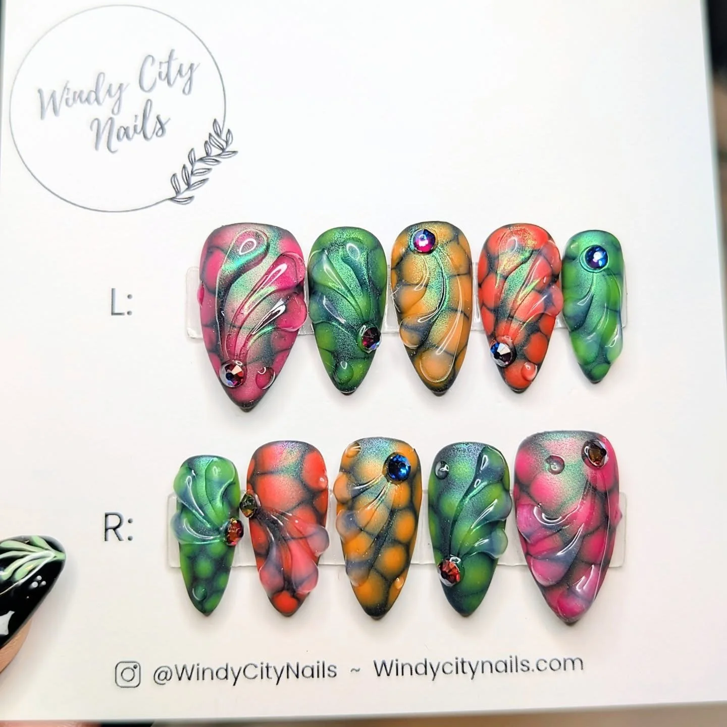 Paging Dr. Frankstylish, STAT! 🧪
These custom press-ons are where neon chaos meets sleek matte.  Blooming gel, 3D texture, matted chrome over black, and just the right amount of shine from those gems.
They&rsquo;re the perfect combo of experimental 