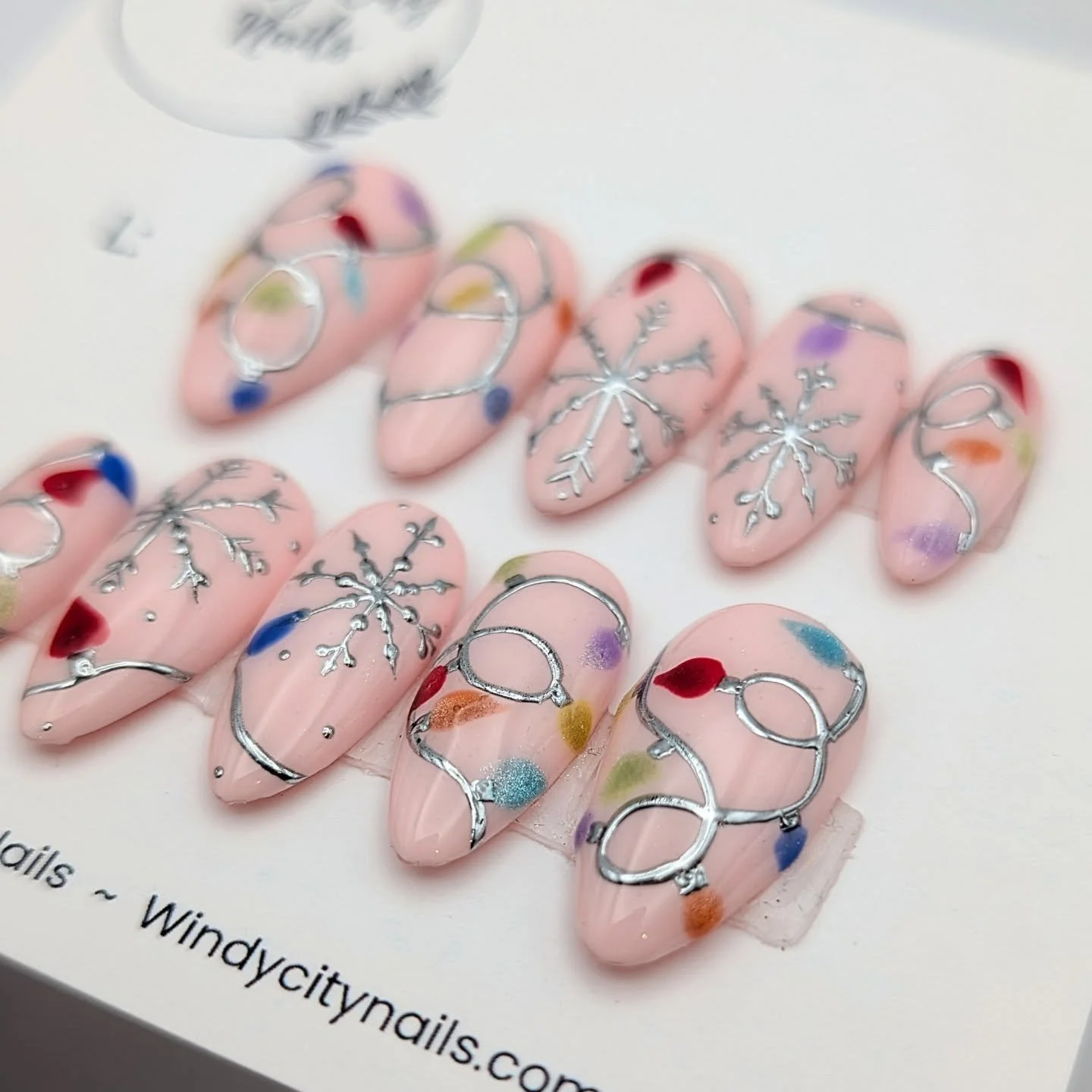Soft pink winter magic❄️🩷
This snowy lights set features hand-painted chrome snowflakes, glowy lights, and a soft pink base to add some charm to the holiday season 

Want your own set of nails without the salon wait? I&rsquo;ll make them in your per