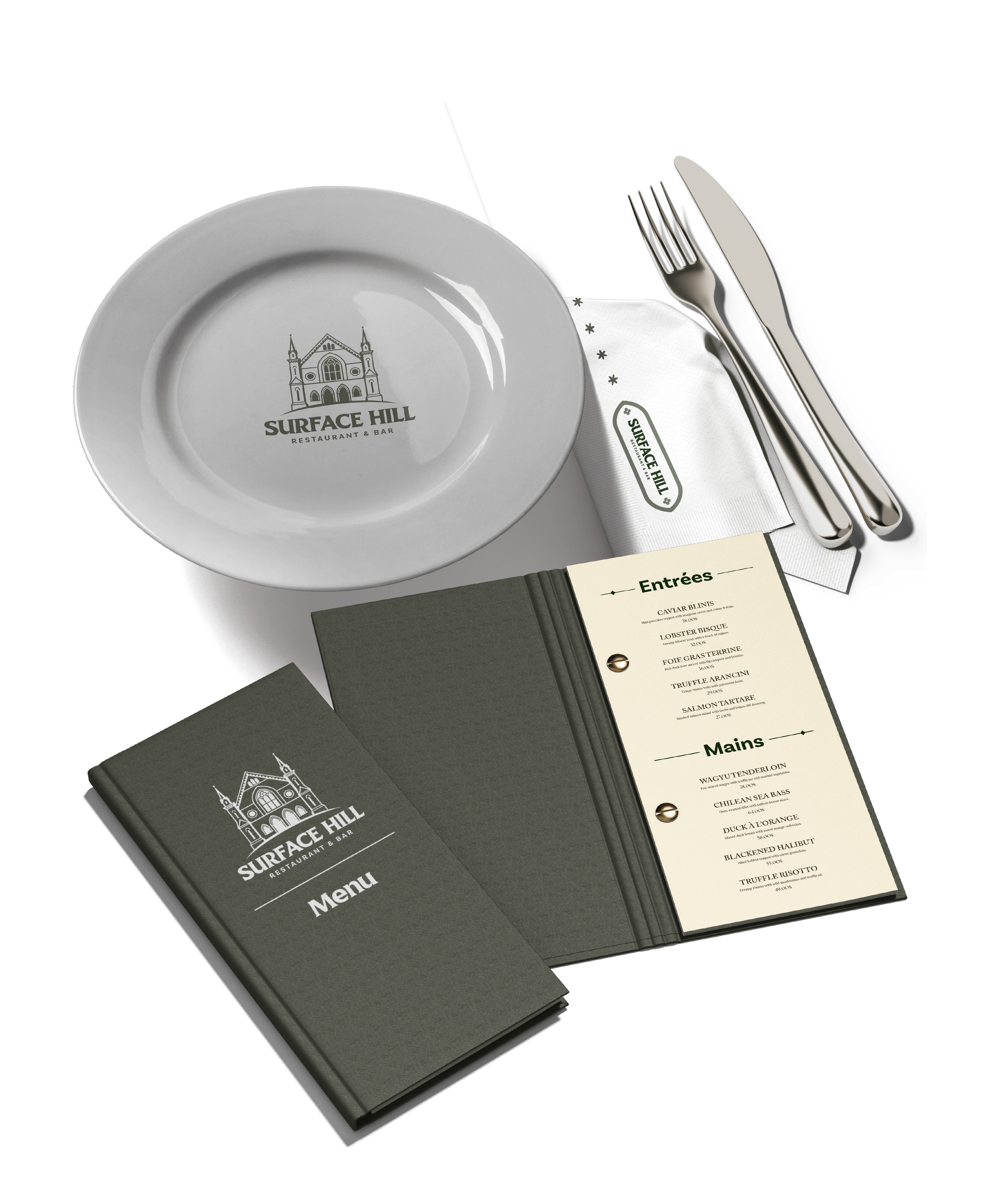 Table setting at Surface Hill restaurant with a white plate, silverware, napkin, menu, and a smaller menu booklet on a white background