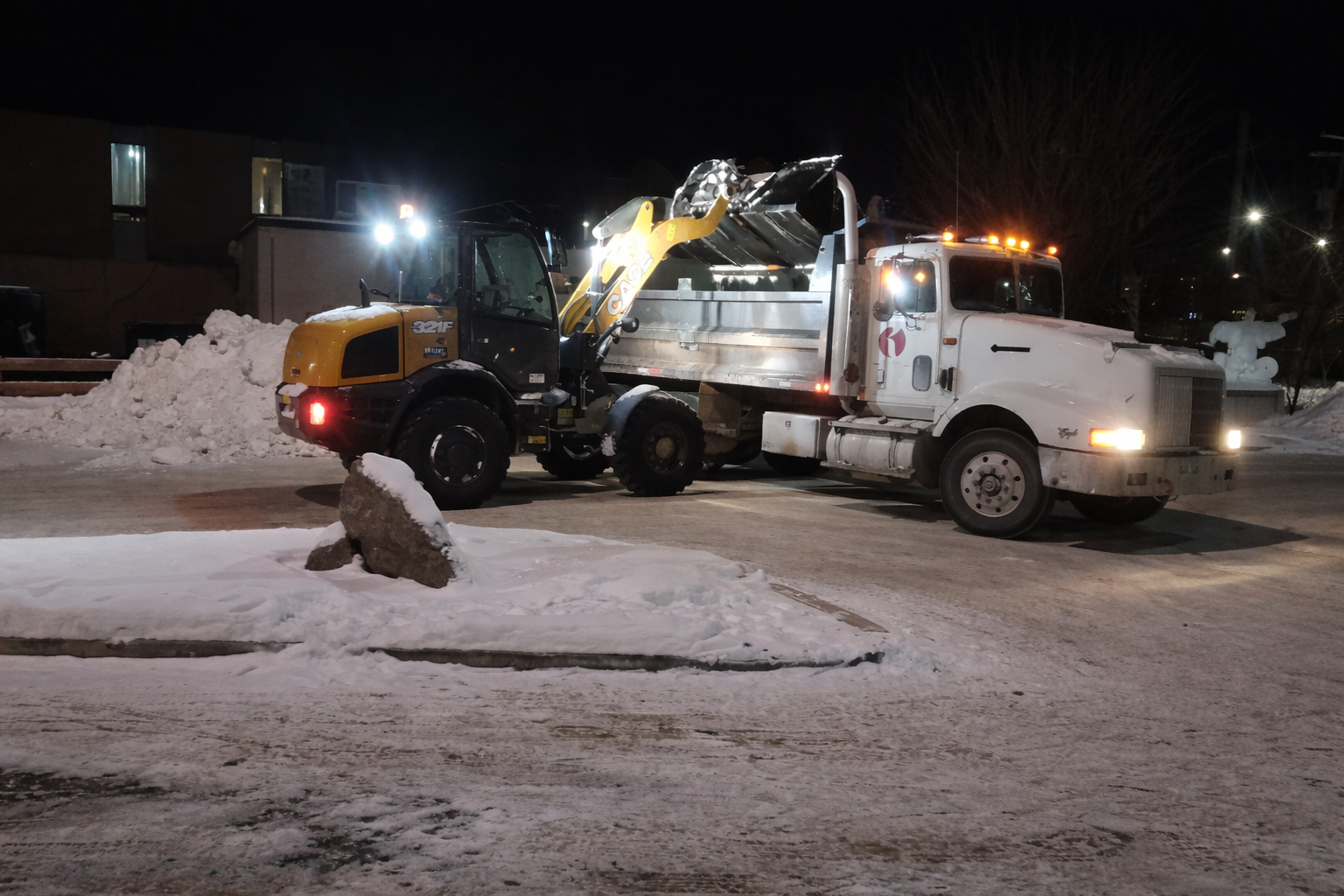 Nighttime snow removal in progress.png