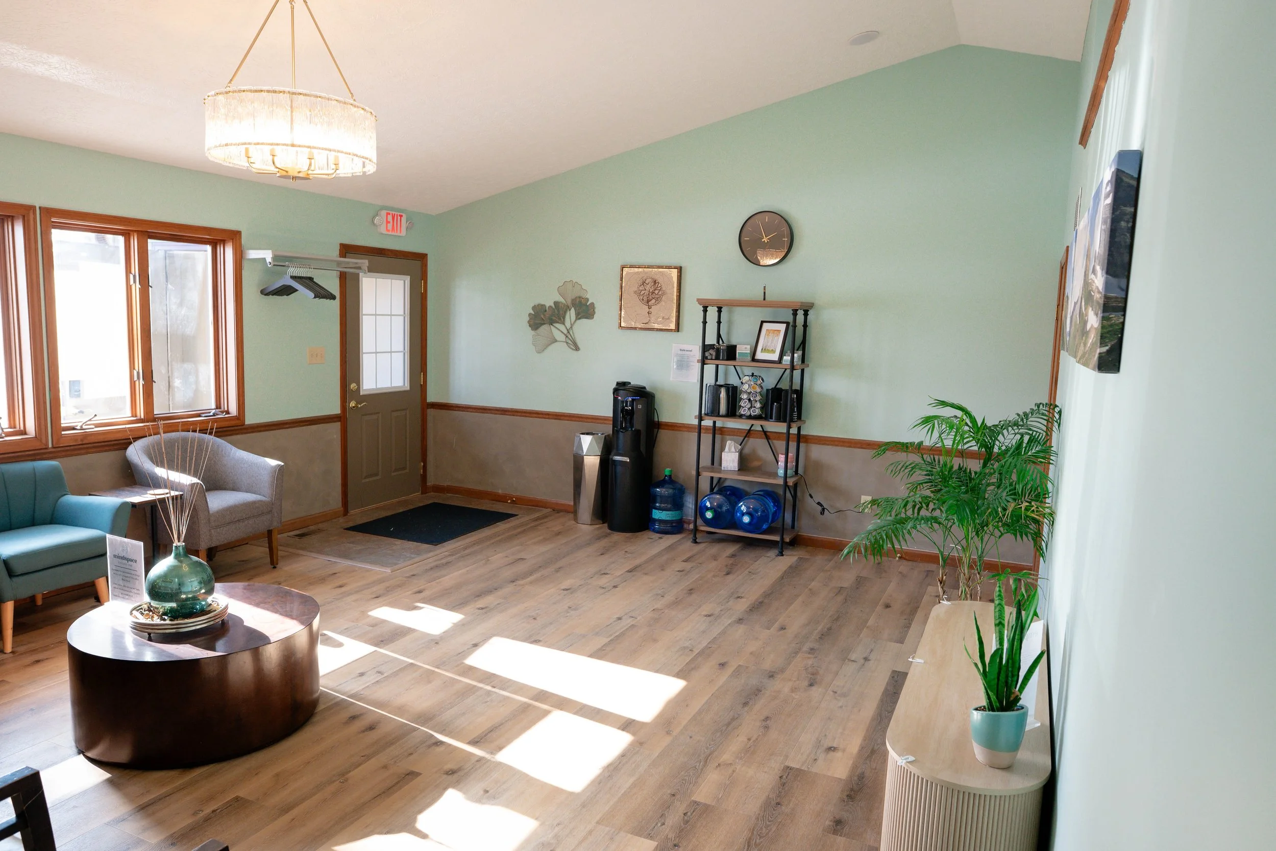 Comfortable shared waiting room featuring complimentary coffee, tea and water at MindSpace Collective for counseling offices, wellness providers, and private office members in Bloomington.