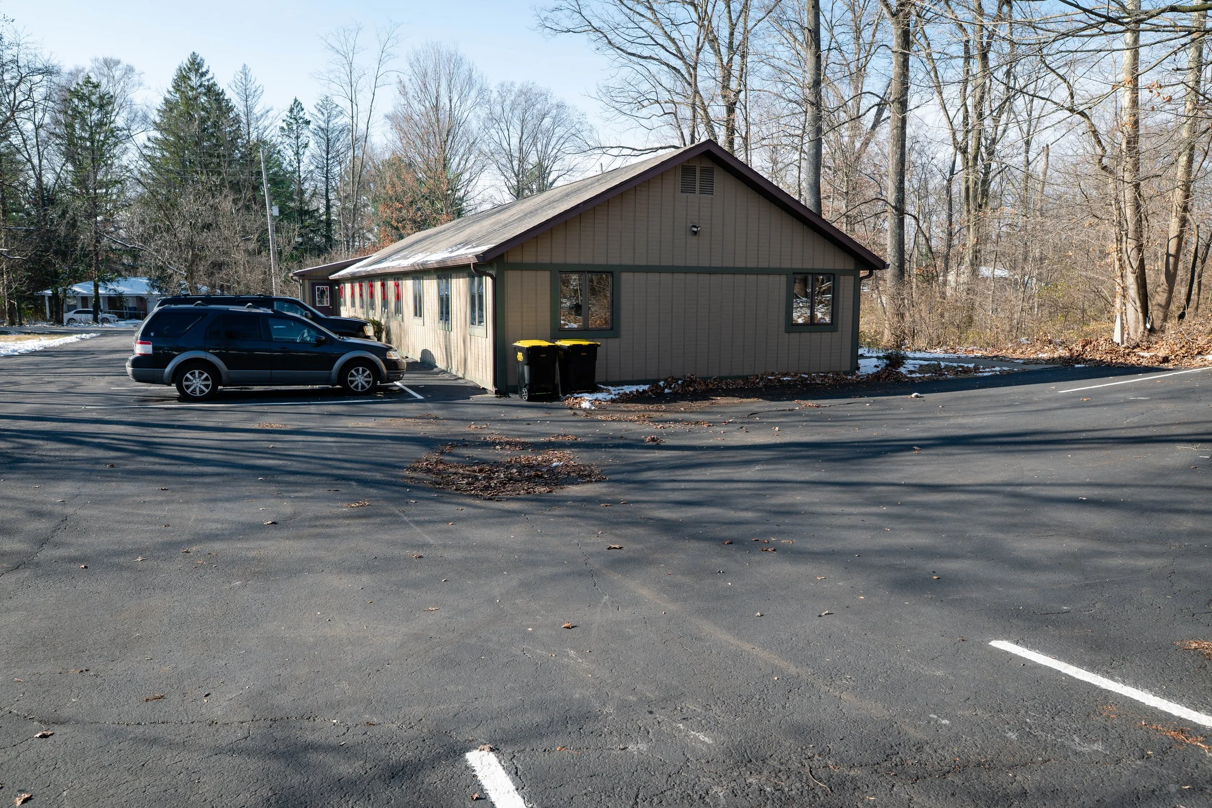 Exterior of MindSpace Collective in Bloomington, Indiana, offering private offices and therapy room rentals with ample on-site parking.