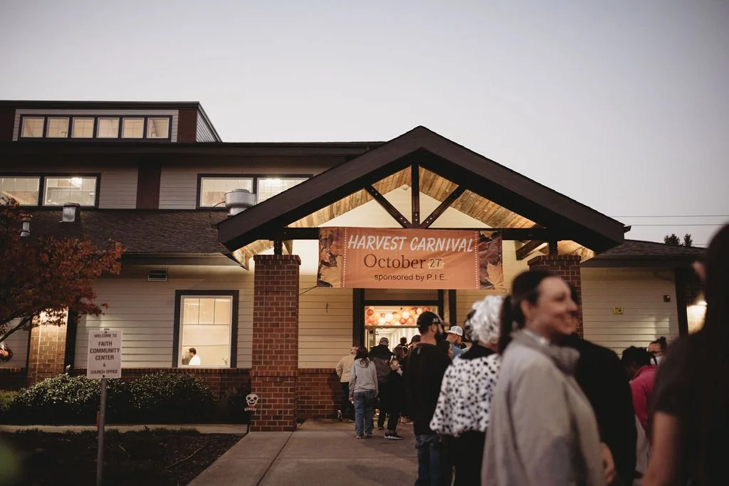 People gathering outside the Faith Community Center during a harvest carnival on October 27.