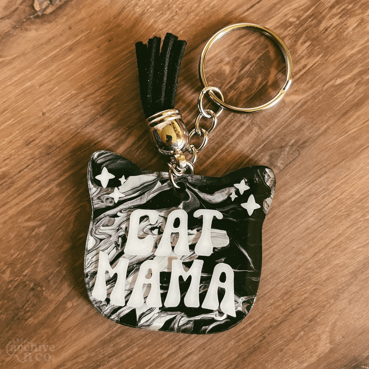 handmade cat mama keychain with dark black and white marbled fur-inspired pattern, retro cat mama lettering, black tassel, and silver keyring