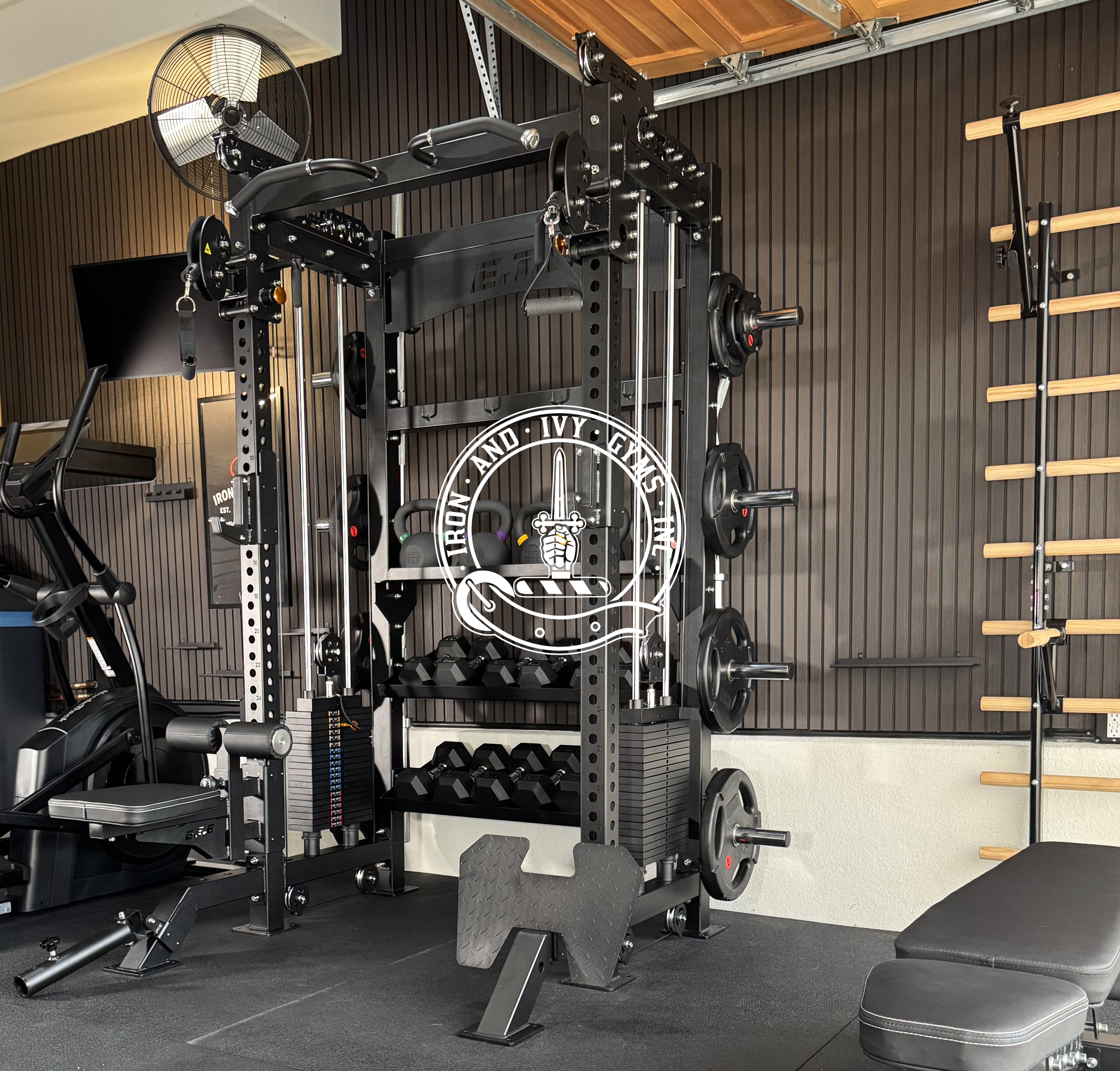 Gym equipment including a weight rack with weights, dumbbells, a bench, a climbing wall, and various exercise machines in a modern fitness center.