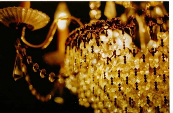 Close-up of a decorative vintage chandelier with pearl-like beads and ornate gold detailing.