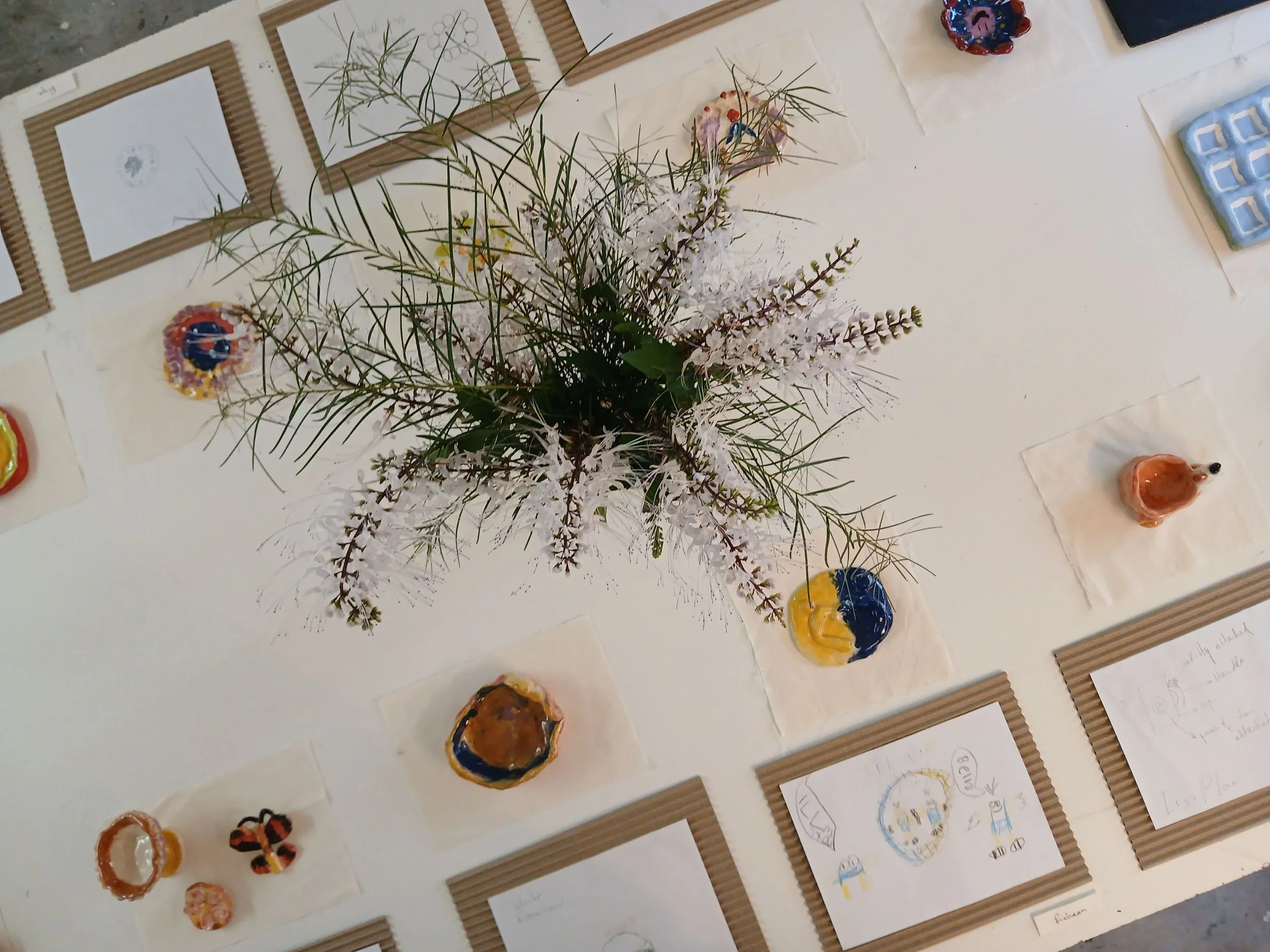 Clay artwork next to planning sketches. End of Term 1 2026 exhibition