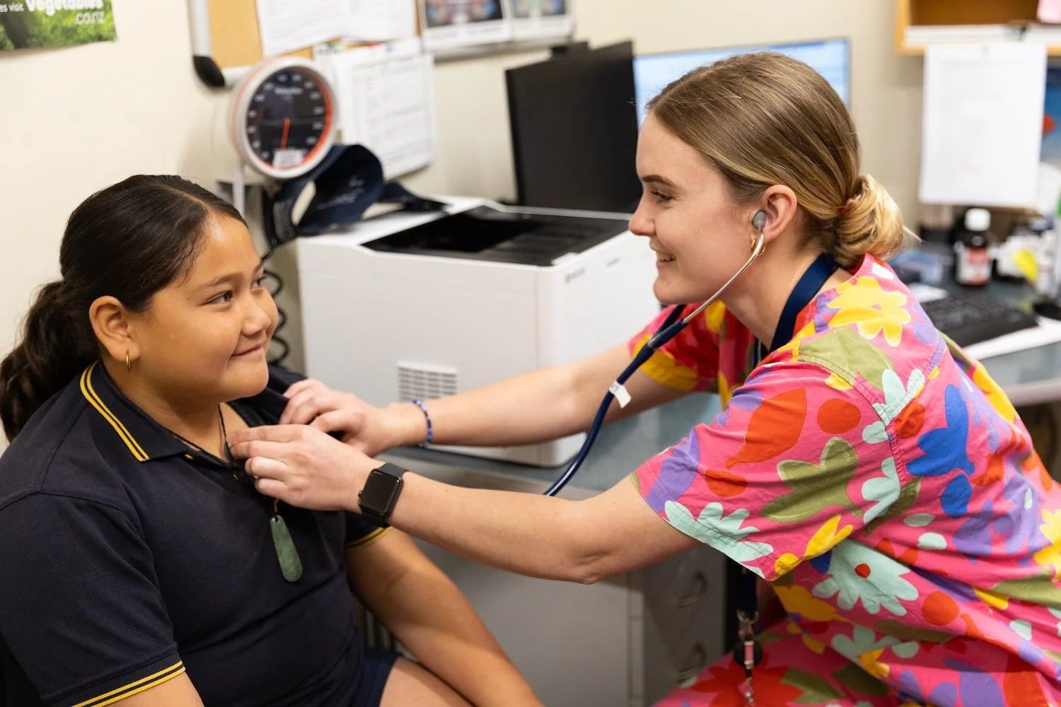 A registered nurse carrying out a routine health check with a young patient at Te Wairoa Medical Centre