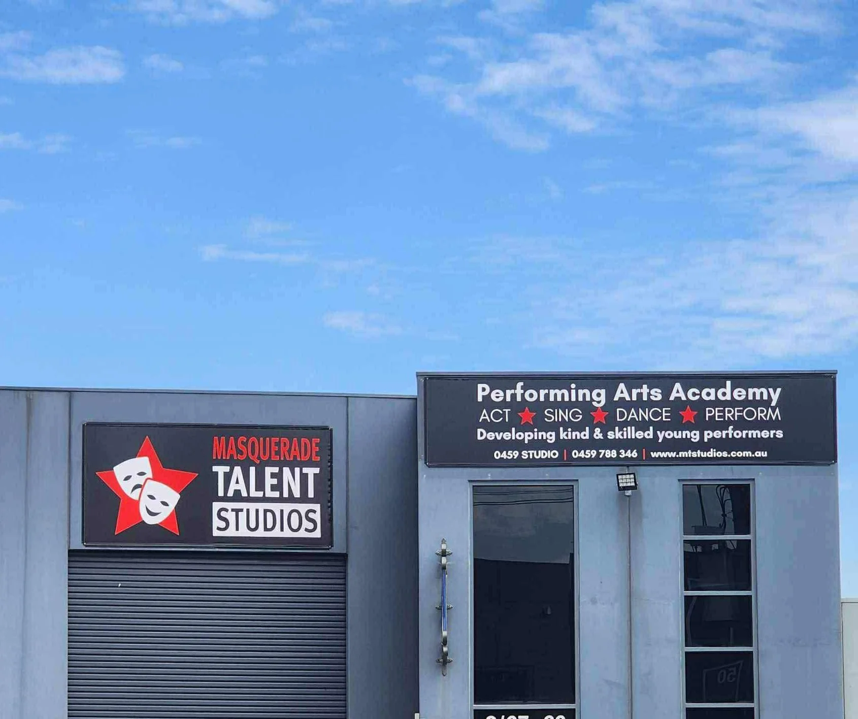 Sign for Masquerade Talent Studios and Performing Arts Academy, advertising acting, singing, dance, and performance classes for young performers, with contact information and website.