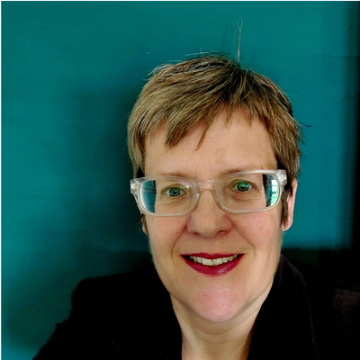 Headshot of Helen smiling against a Teal Green background