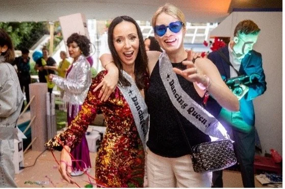 Two women celebrating at a Mamma Mia inspired party